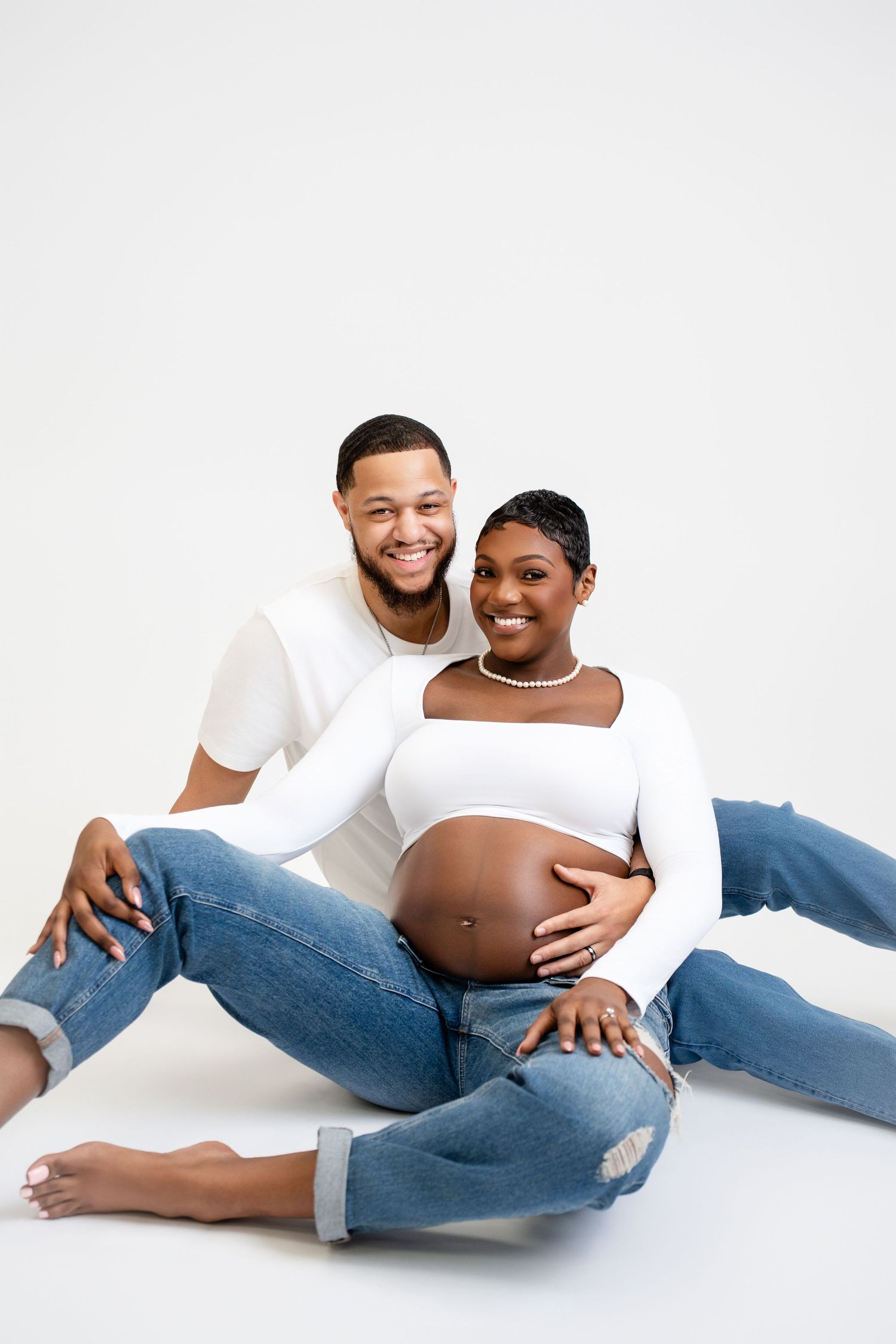 Metro Detroit maternity photographer capturing an expecting mother and husband in studio