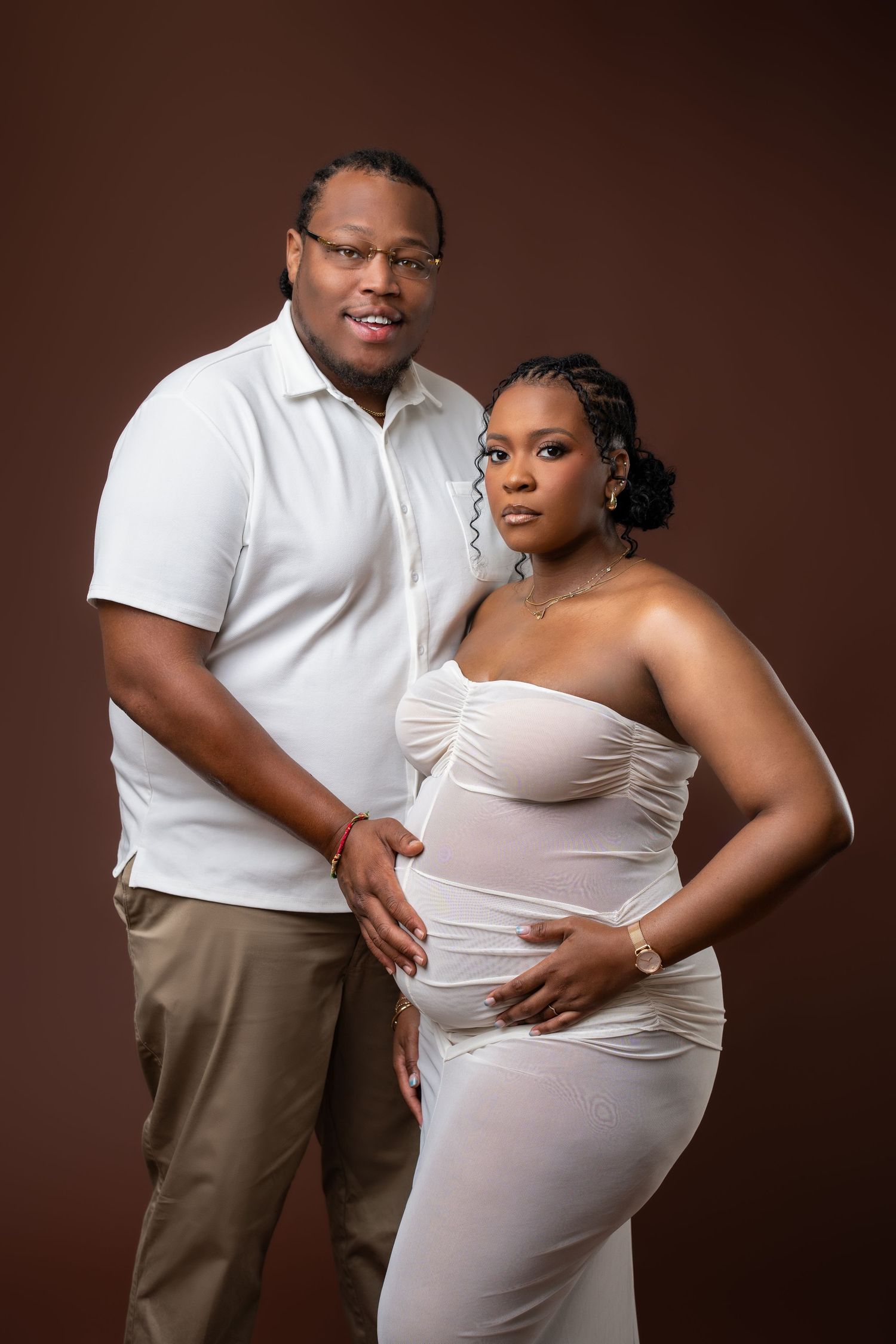 Metro Detroit maternity photographer capturing an expecting mother and husband in studio