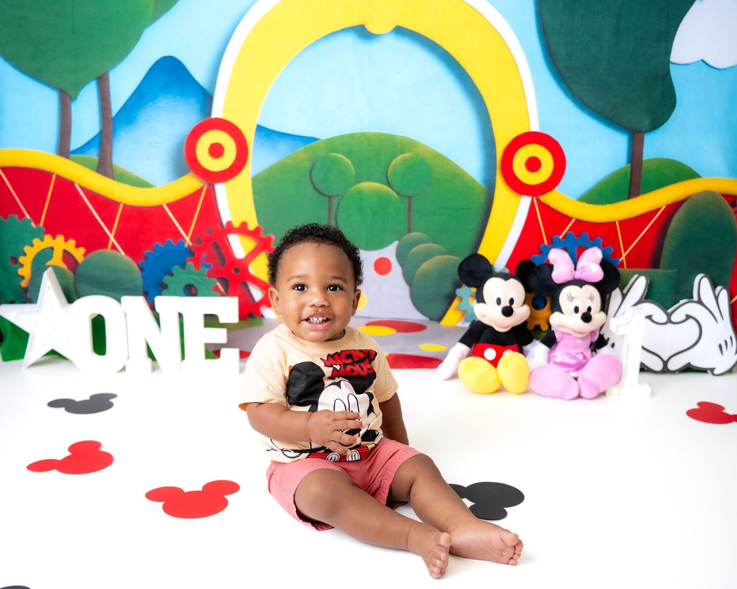 Metro Detroit children photographer Disney themed photo setup with Mickey Mouse plush toys and ONE letter sign.