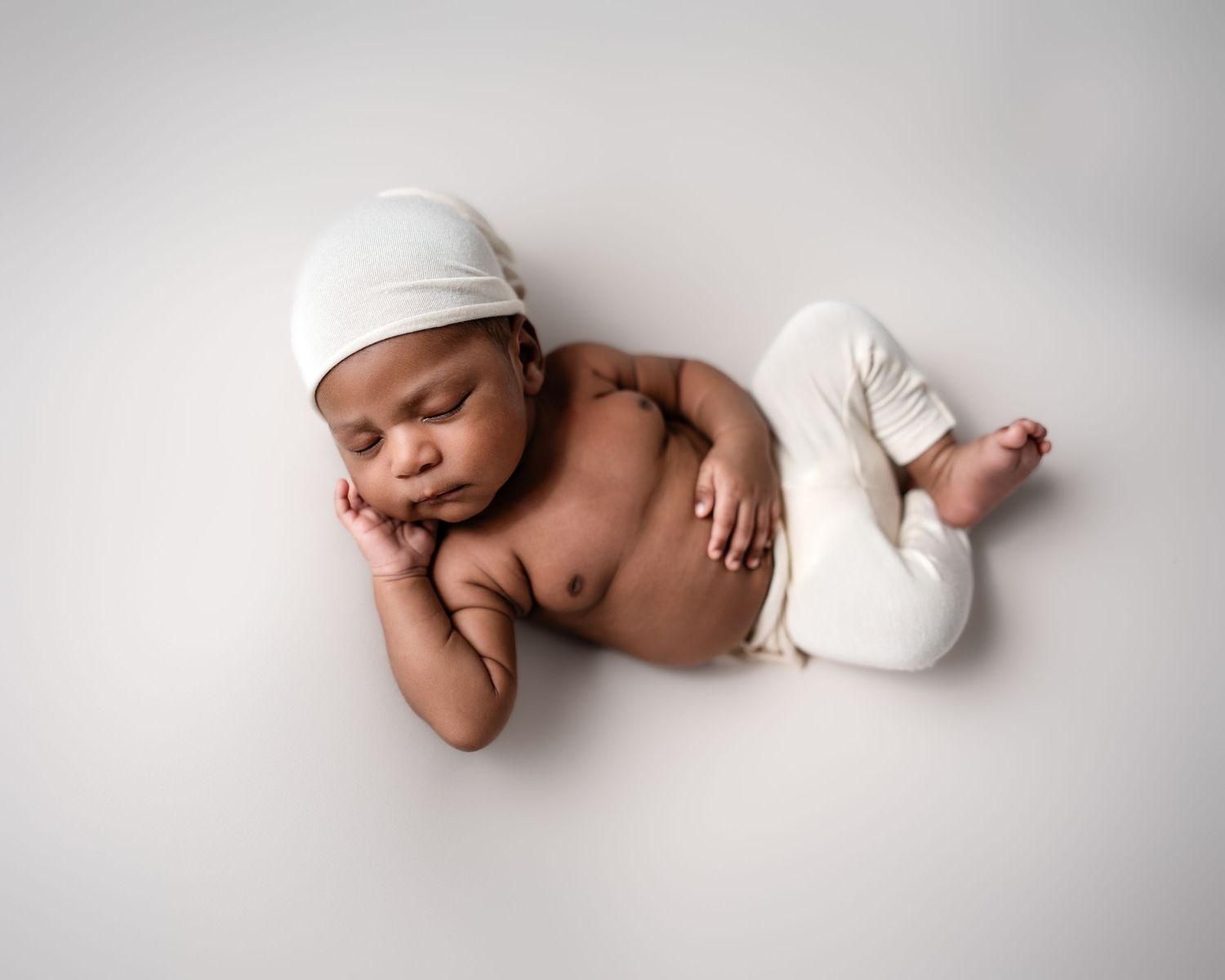 Metro Detroit newborn photographer capturing a peaceful newborn portrait in studio