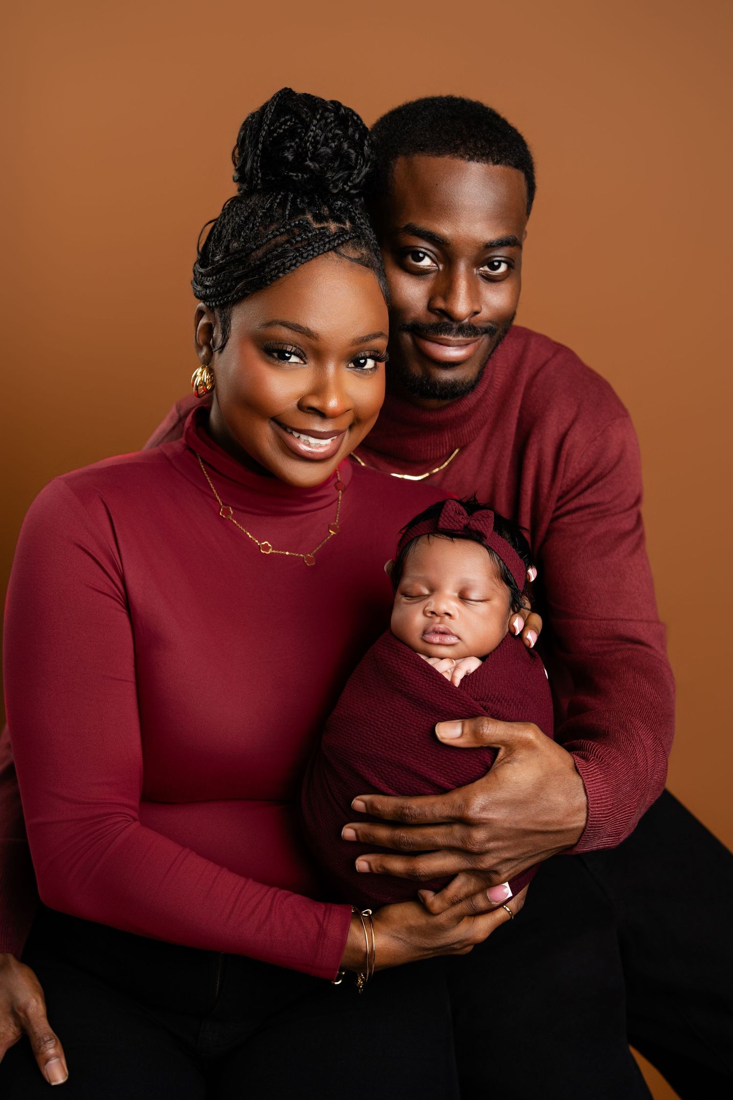 Metro Detroit family photographer capturing a Loving family in burgundy sweaters poses together against
