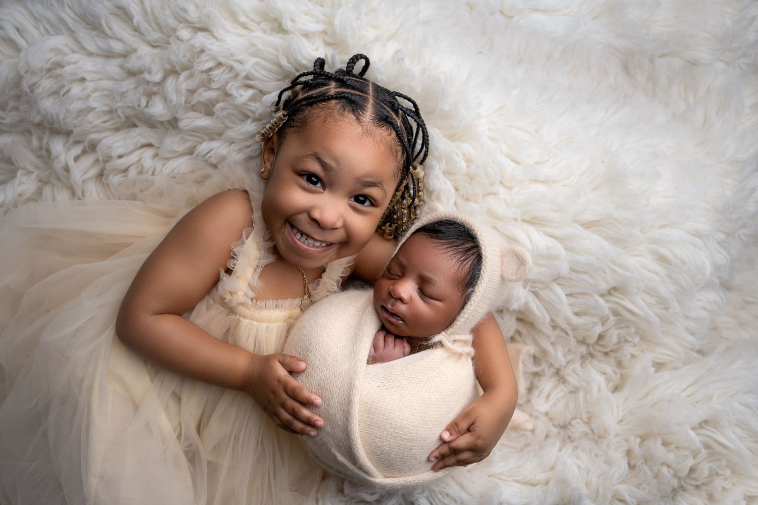 Metro Detroit newborn photographer capturing a peaceful newborn portrait in studio with sister