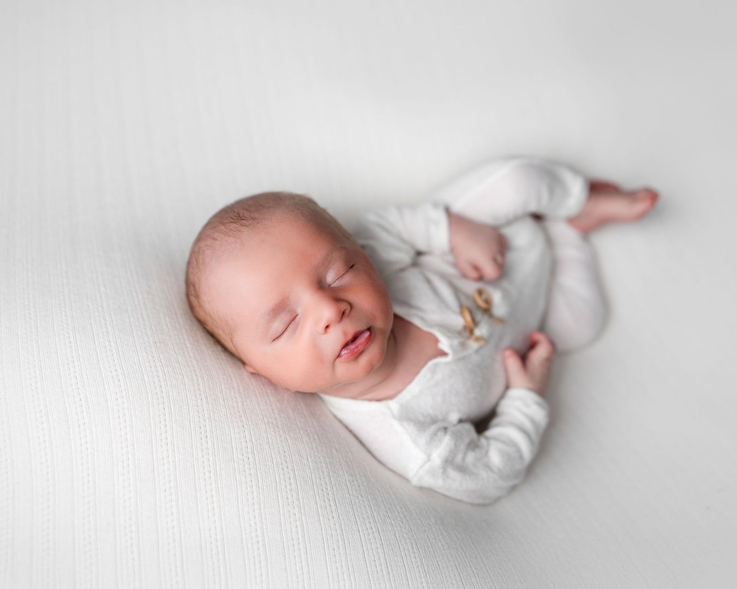 Metro Detroit newborn photographer capturing a peaceful newborn portrait in studio