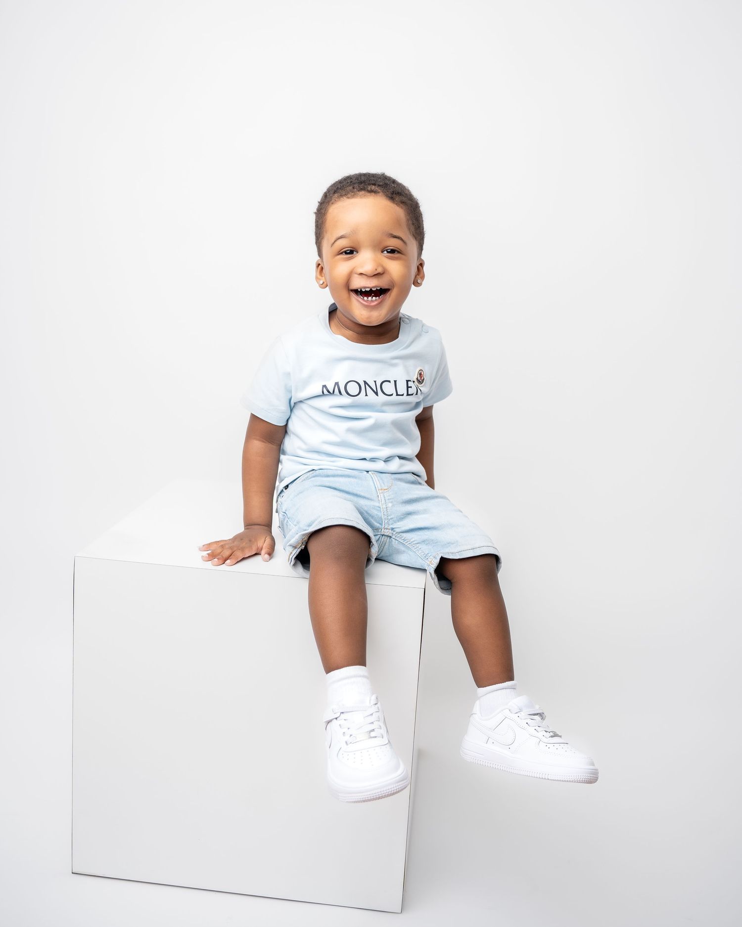 Metro Detroit children photographer Clean white minimalist photo studio setup with simple geometric blocks.