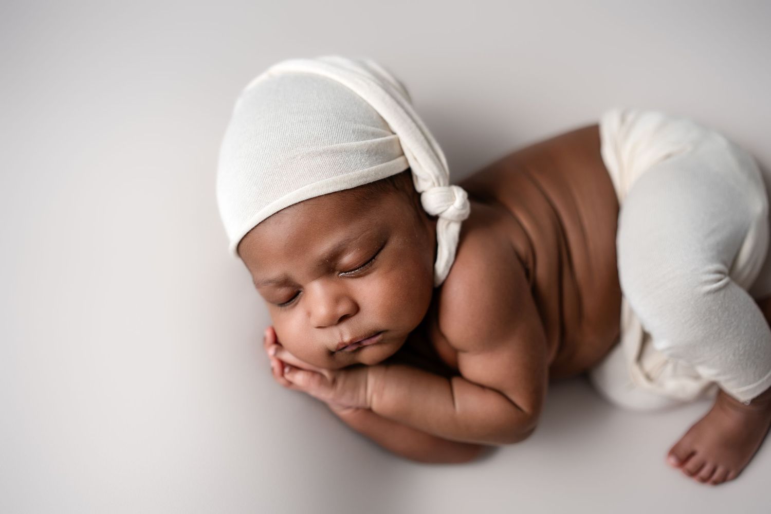 Metro Detroit newborn photographer capturing a peaceful newborn portrait in studio
