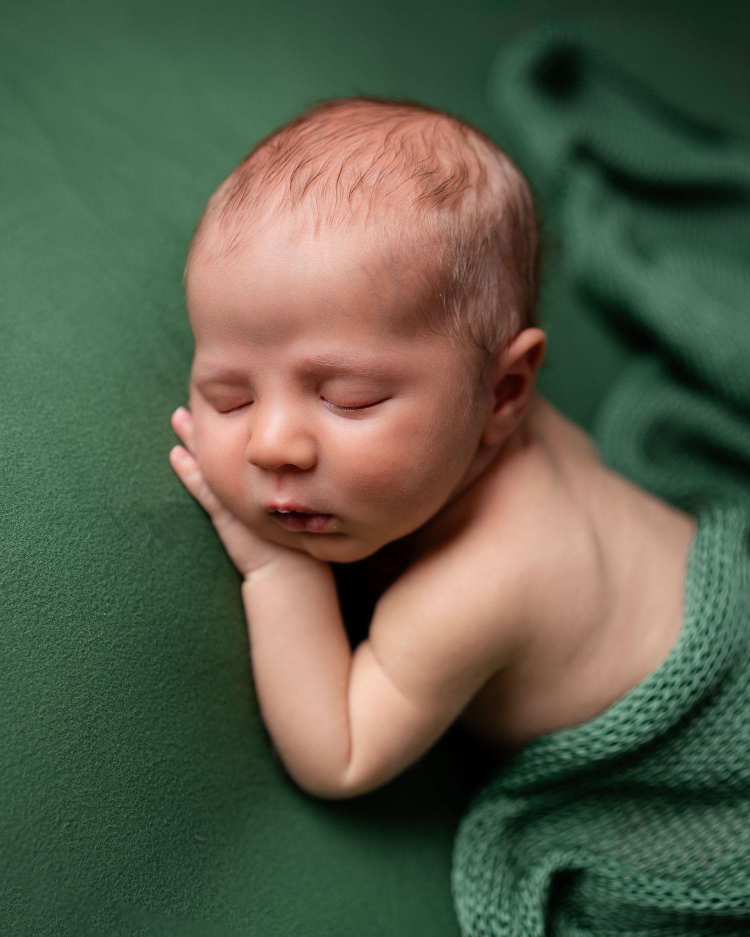 Metro Detroit newborn photographer capturing a peaceful newborn portrait in studio