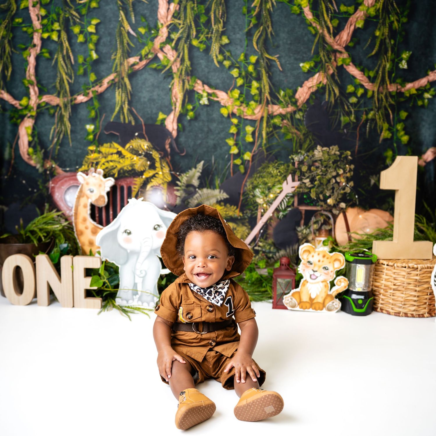 Metro Detroit children photographer Safari-themed first birthday photo shoot with jungle decorations and props.
