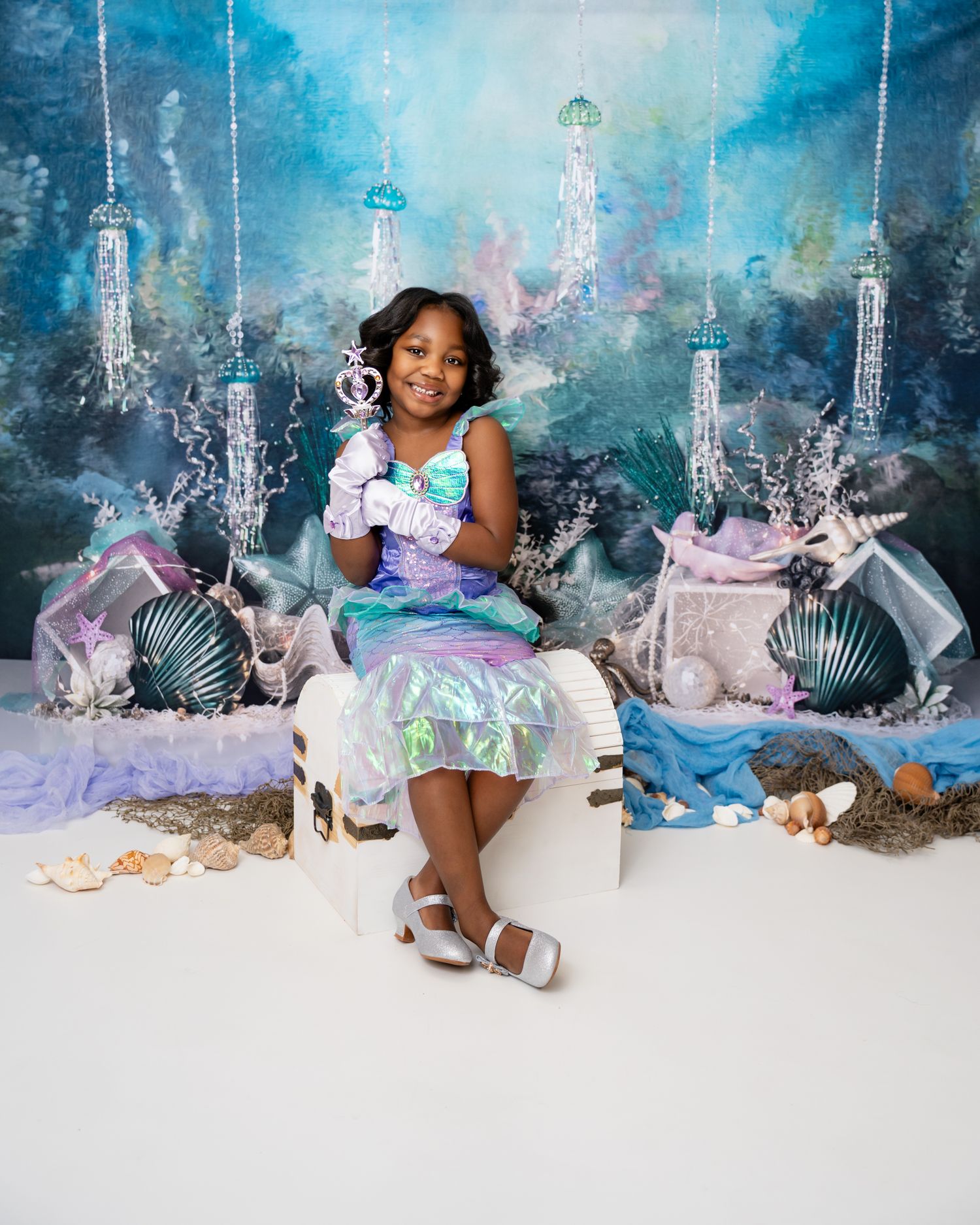 Metro Detroit children photographer photographing a playful toddler in studio A child in a purple and blue dress poses