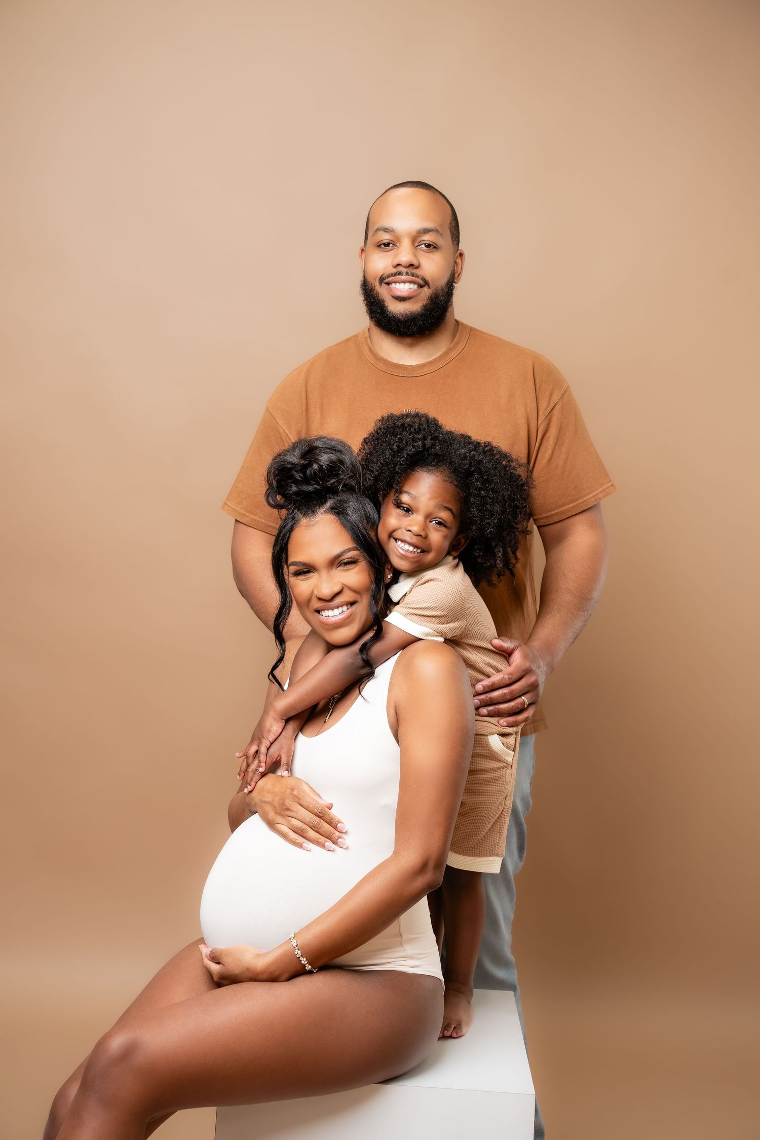 Metro Detroit maternity photographer capturing an expecting family in studio