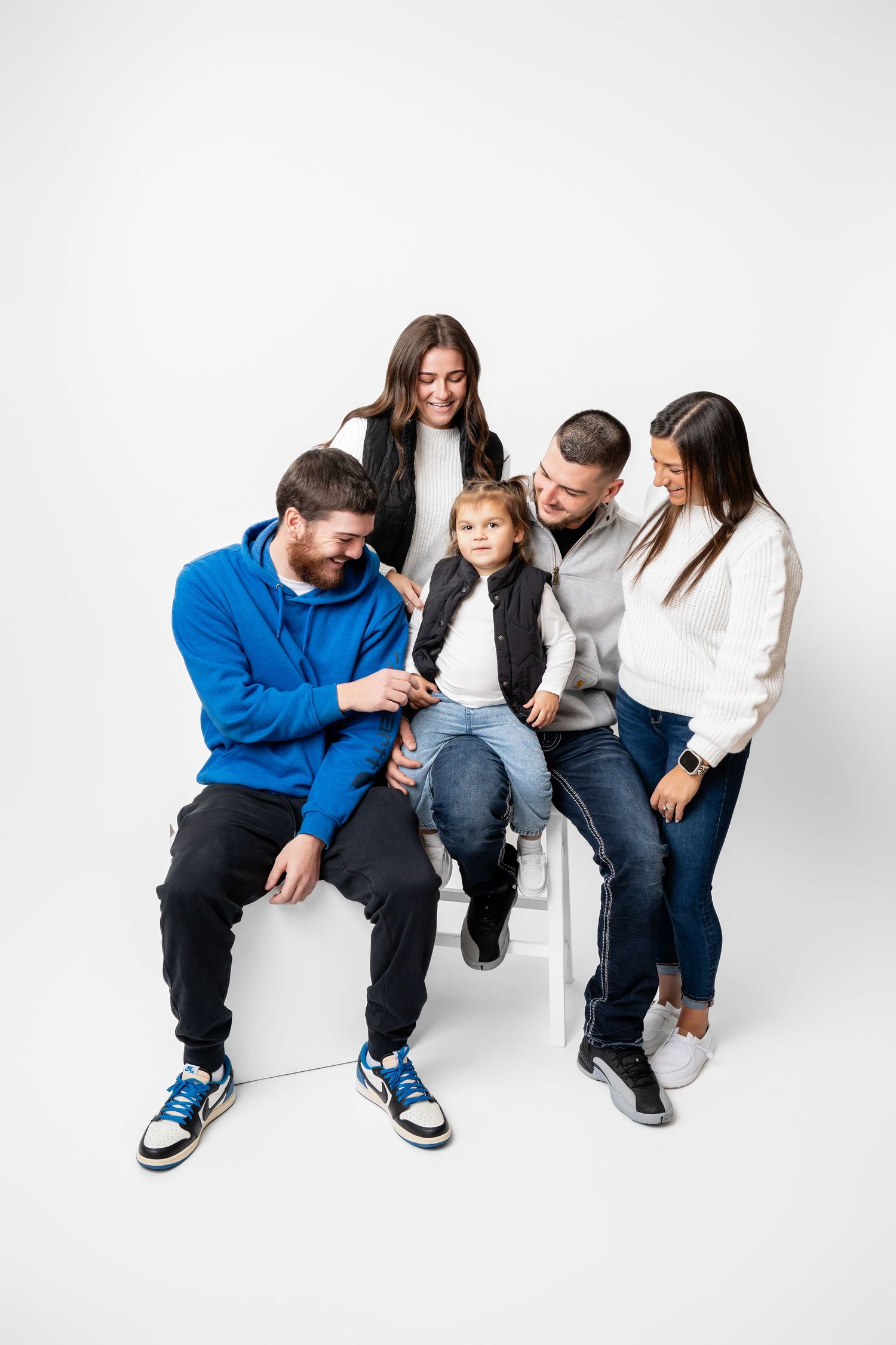 Metro Detroit family photographer capturing A family in casual attire siting together