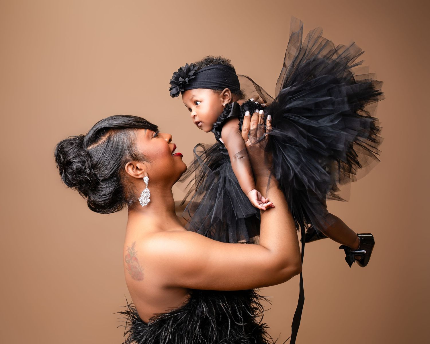 Metro Detroit family photographer capturing Artistic studio portraits featuring dramatic black tulle dress against neutral backdrop.
