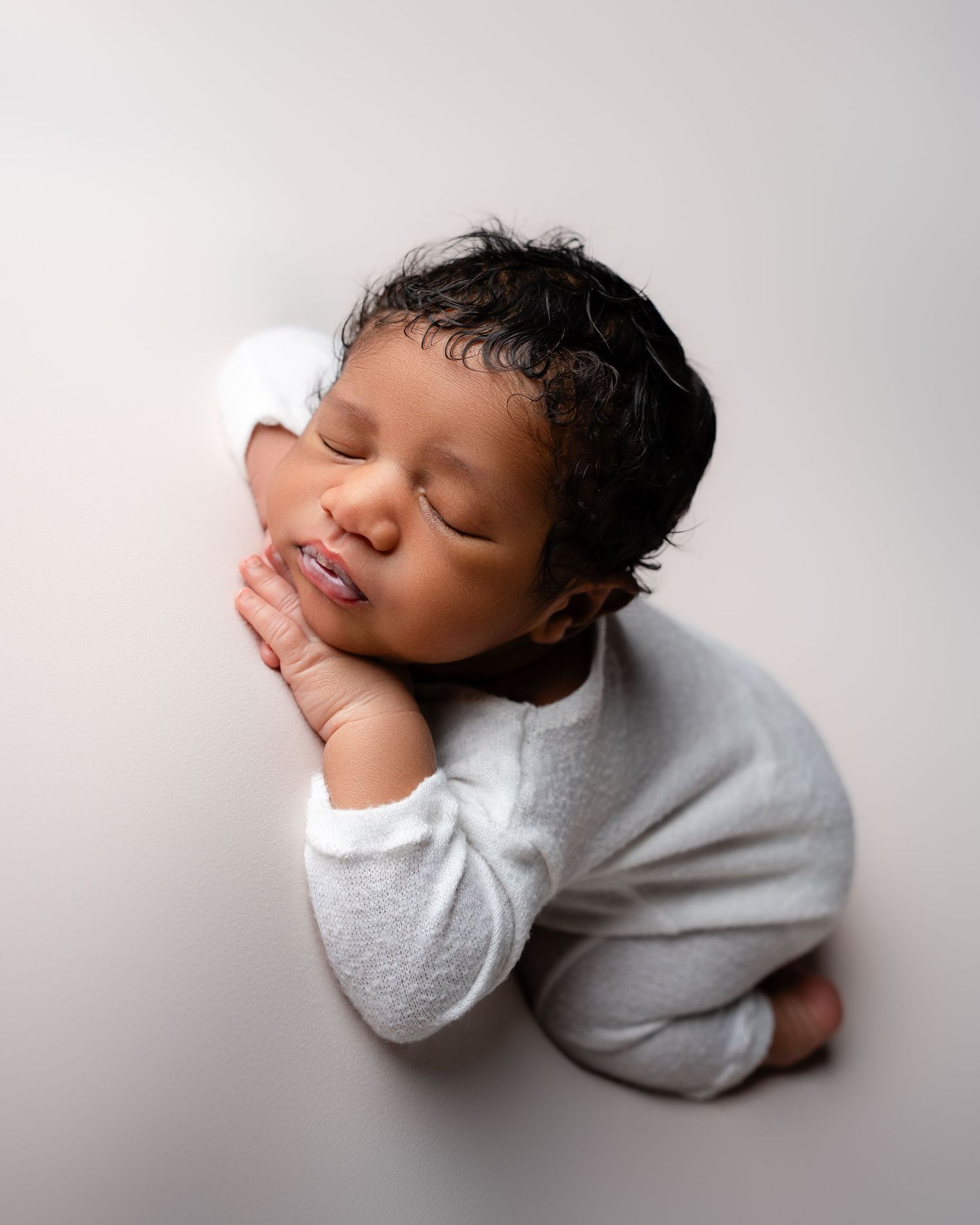 Metro Detroit newborn photographer capturing a peaceful newborn portrait in studio