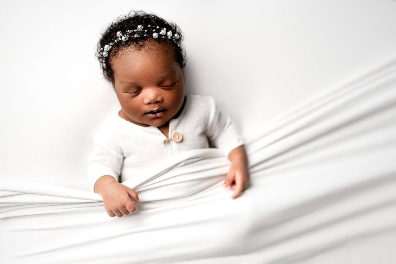 Metro Detroit newborn photographer capturing a peaceful newborn portrait in studio