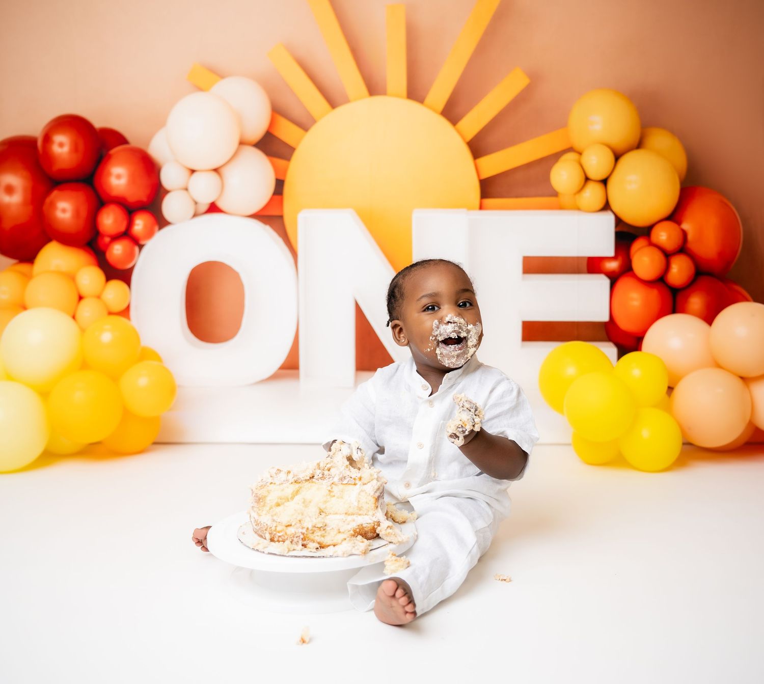 Metro Detroit children photographer photographing toddler in studio for First birthday cake smash photoshoot