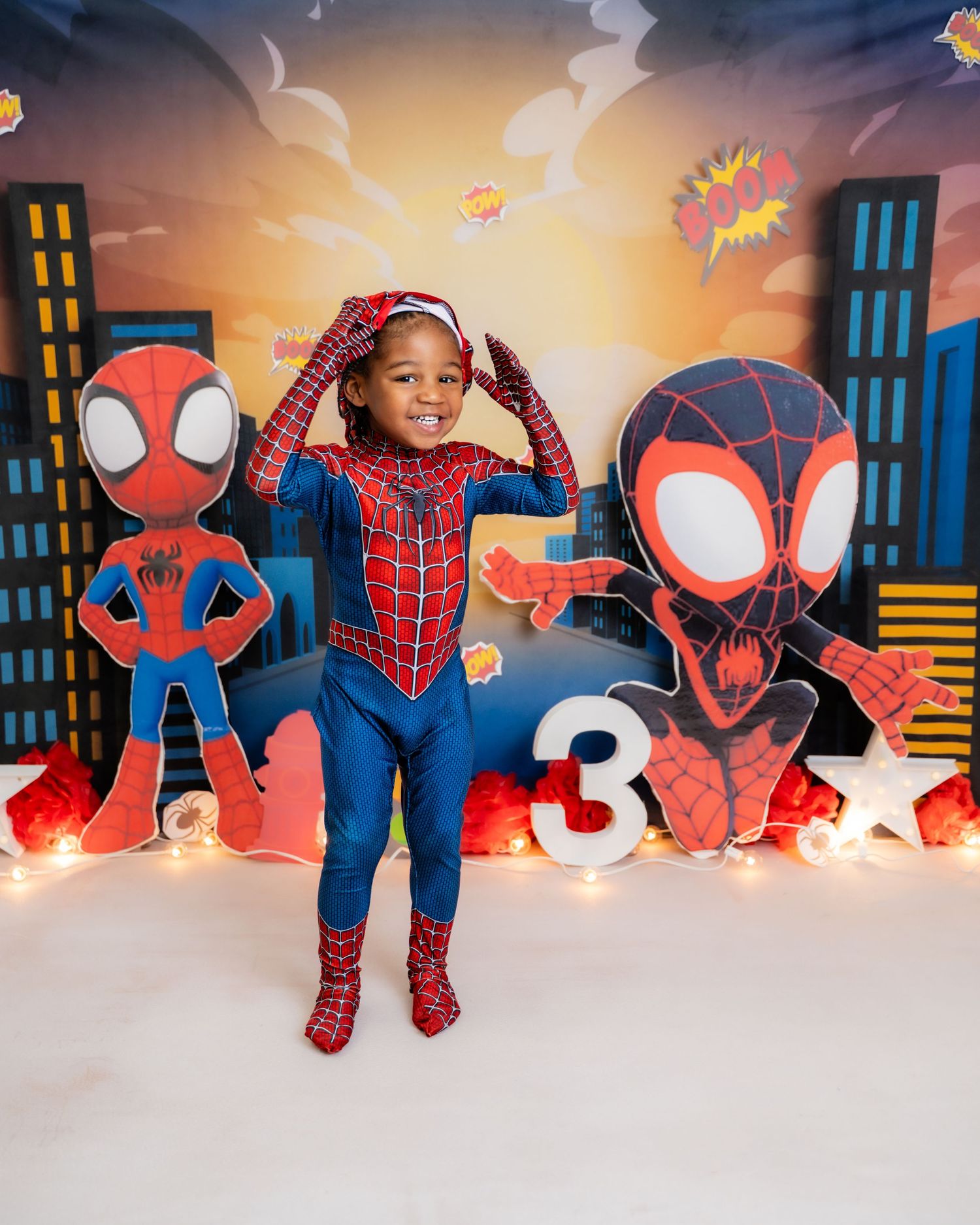 Metro Detroit children photographer photographing a playful toddler in studio Spider-Man themed birthday photoshoot