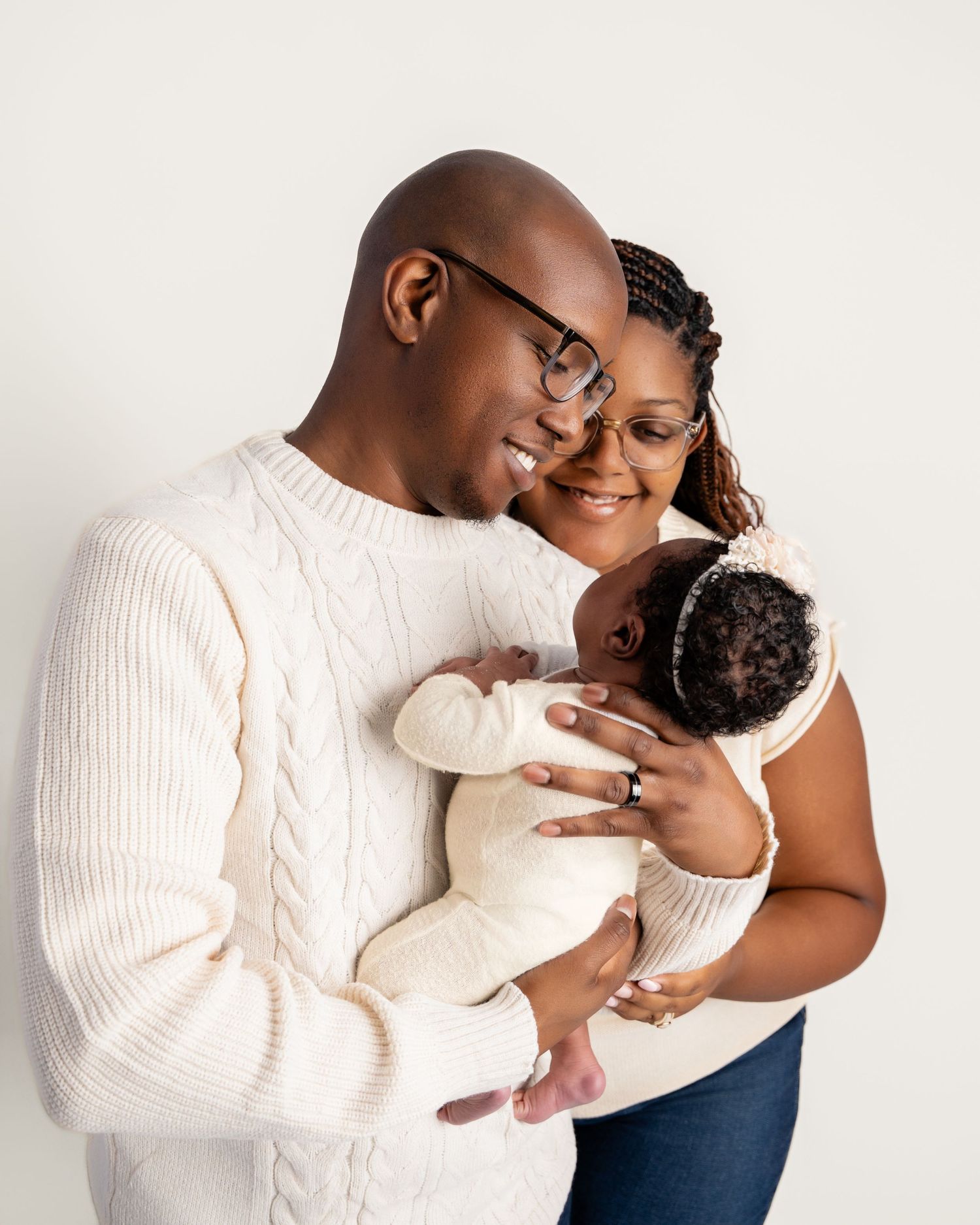 Metro Detroit newborn photographer capturing a peaceful newborn  with parents portrait in studio