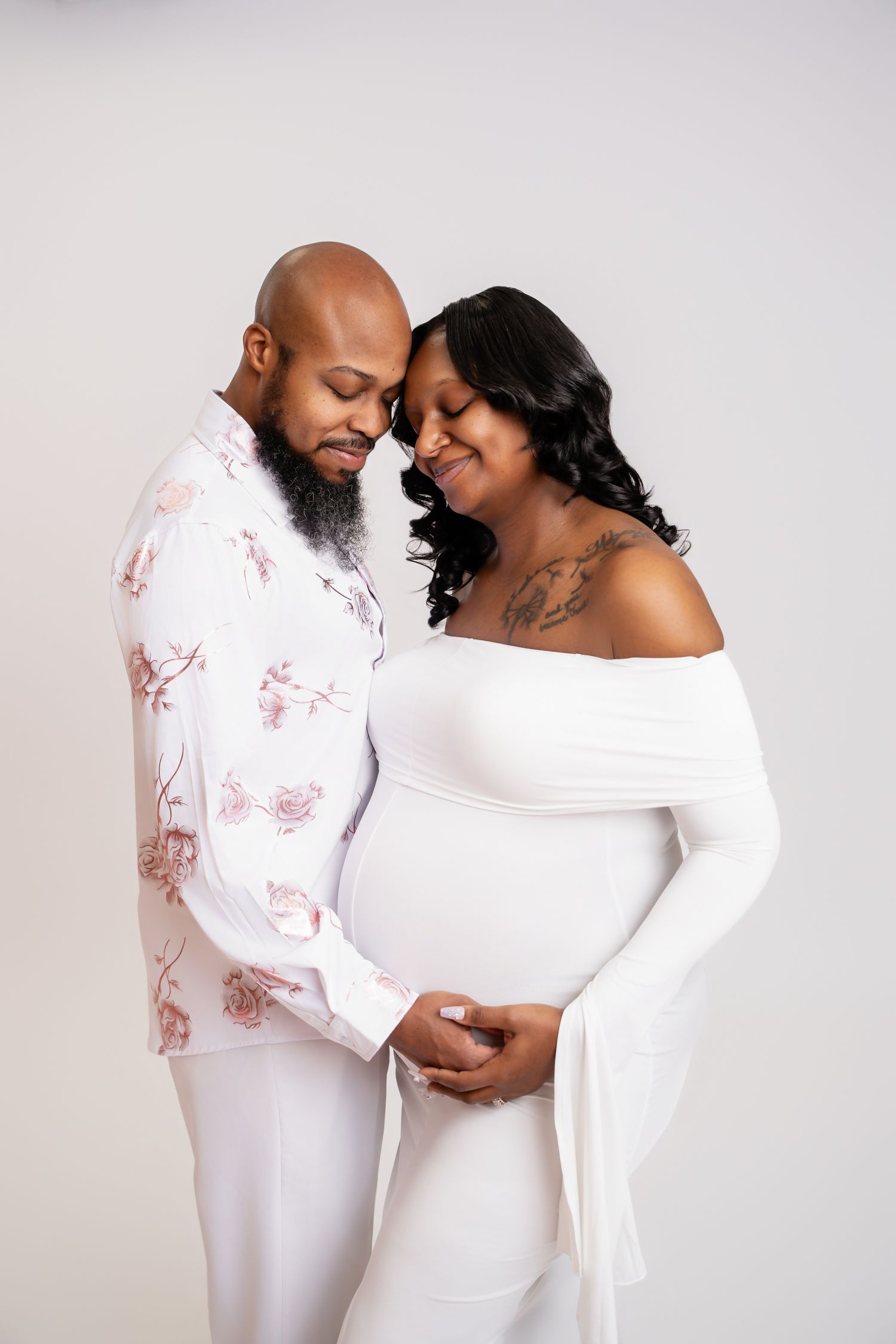 Metro Detroit maternity photographer capturing an expecting mother with husband in studio