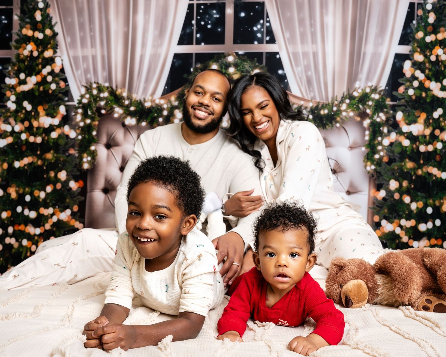Metro Detroit family photographer capturing A family wearing white and red outfits poses for holiday