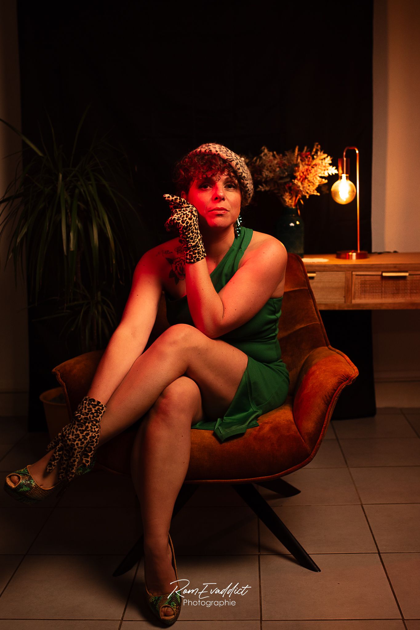 femme look pin up robe crayon verte béret et gants léopard assise jambe croisé dans un fauteuil velour- portrait boudoir confiance en soi