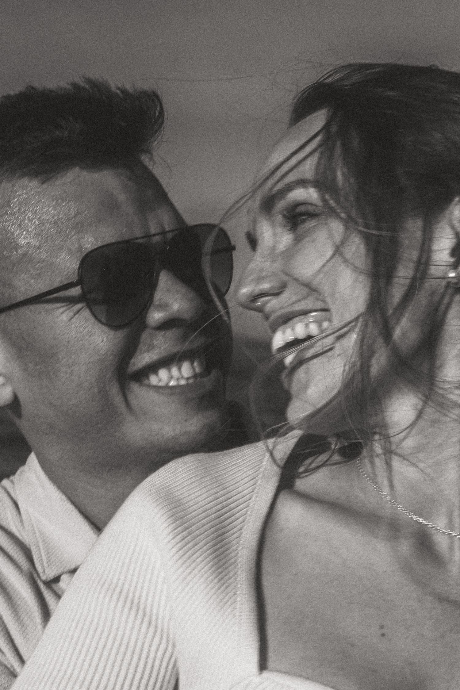 Close-up black and white portrait of a happy couple sharing an intimate moment.