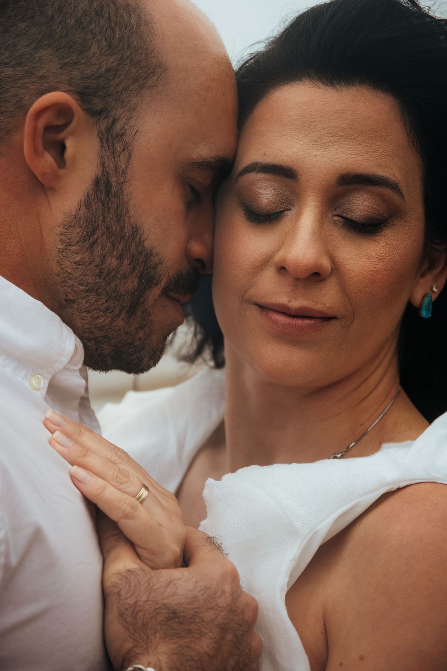An intimate close-up portrait captured during a beach photoshoot.