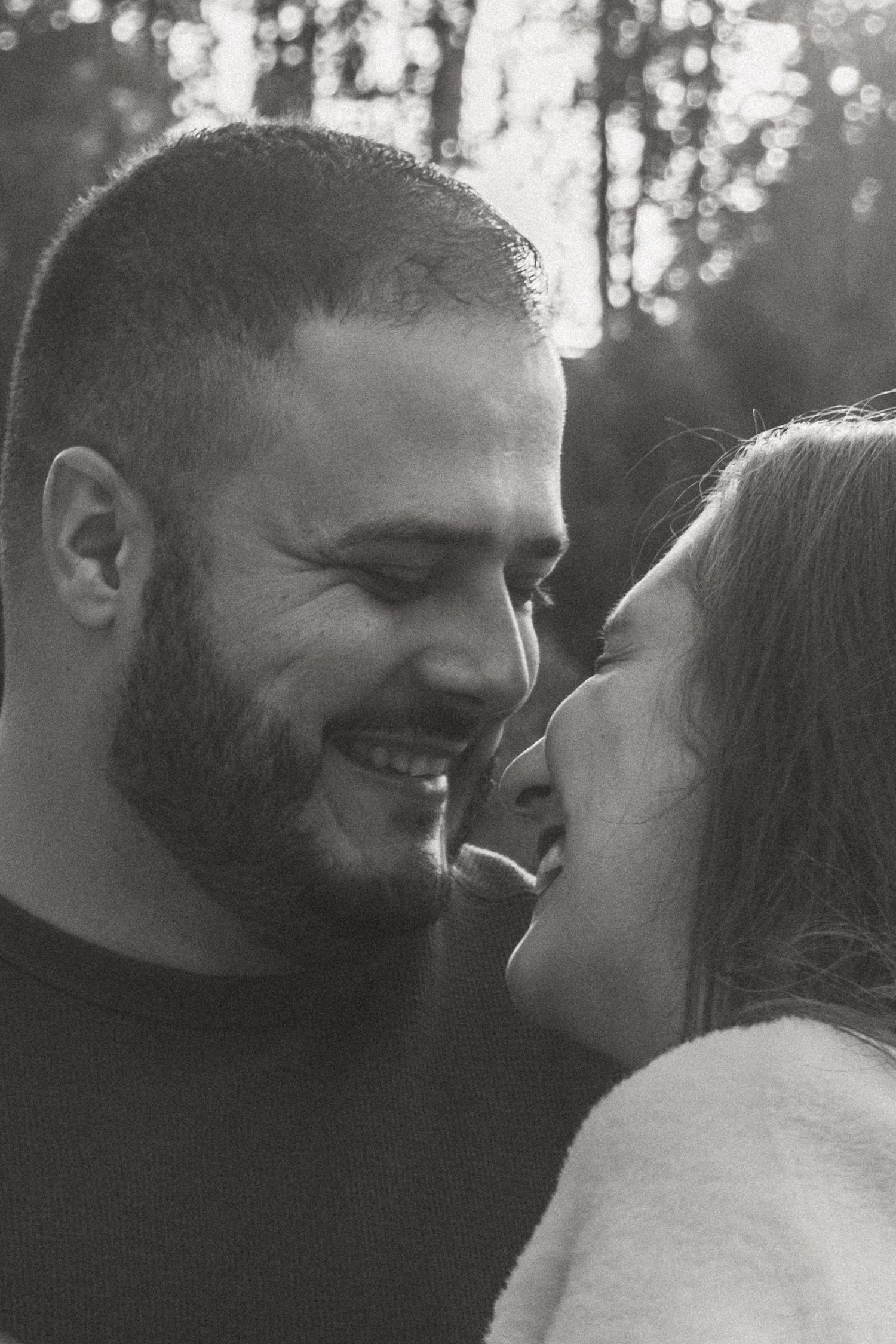 Intimate black and white portrait sequence showing tender moments between a couple.