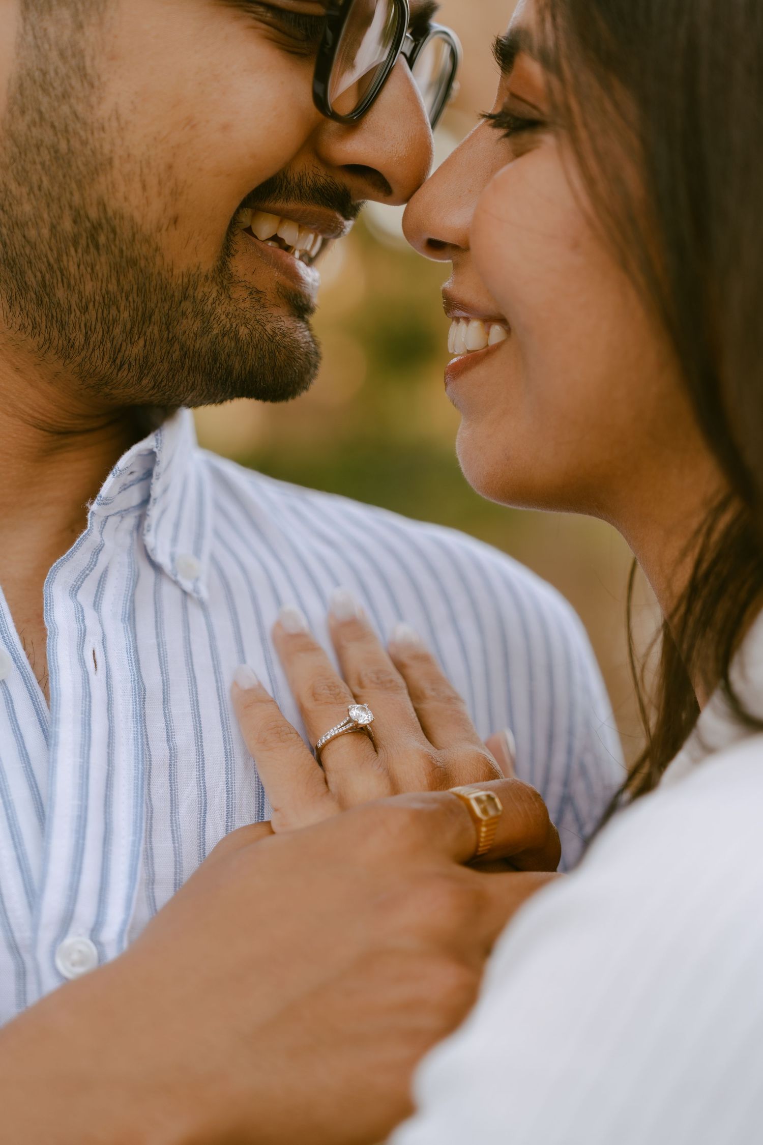 Happy couple sharing a romantic moment, woman wearing an engagement ring, close-up portrait of love and joy.