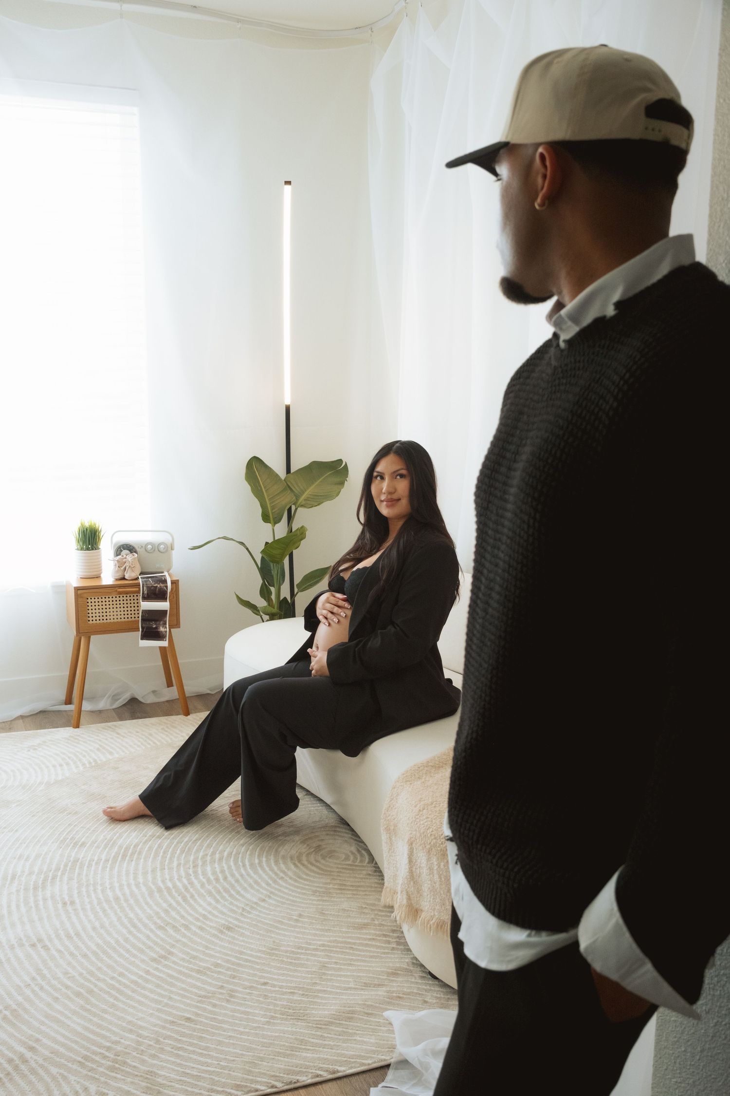 A minimalist white room setting with a houseplant and natural lighting creating a serene atmosphere.