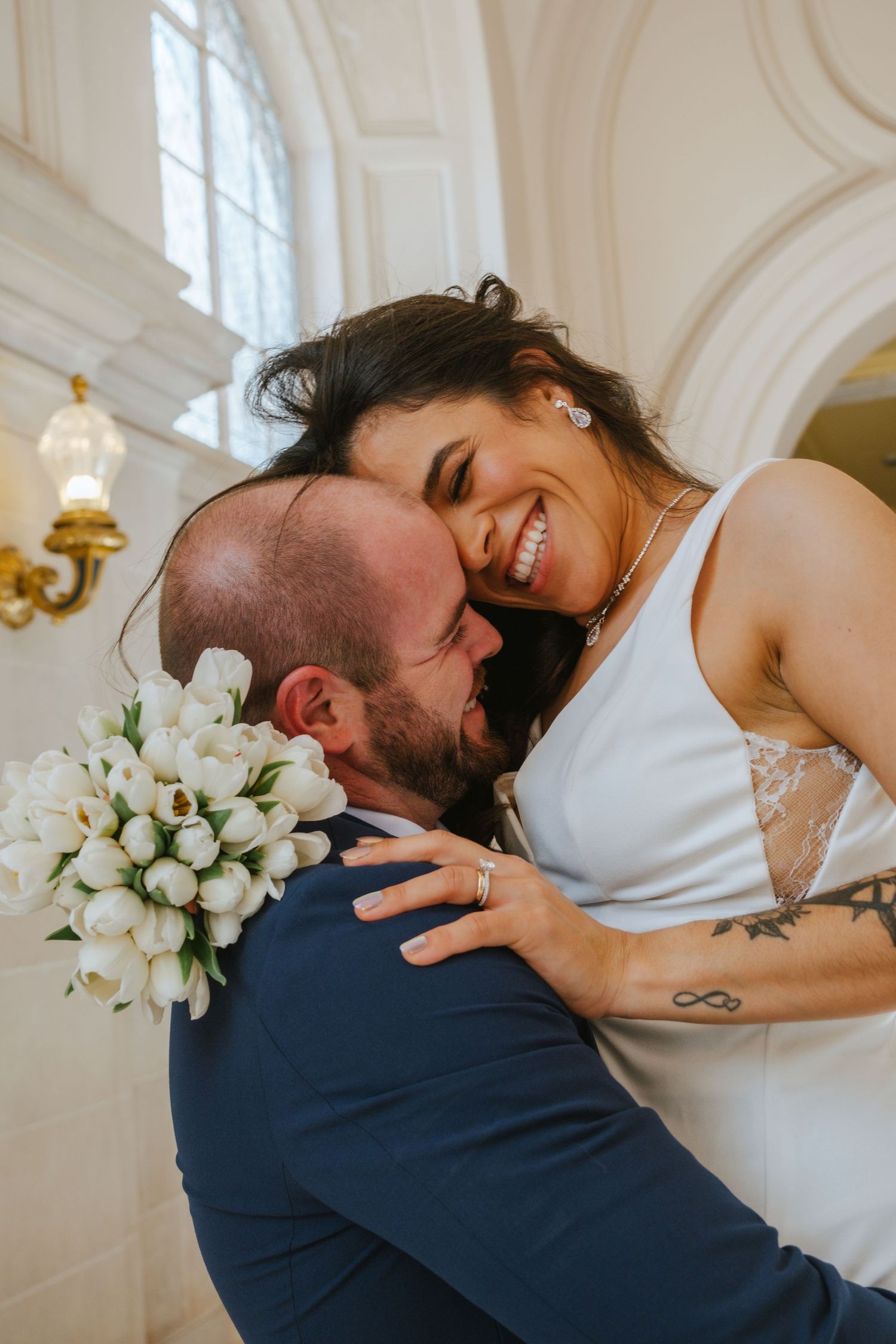 A romantic wedding moment captured in a series of five intimate photos showing a couple embracing in a bright venue.