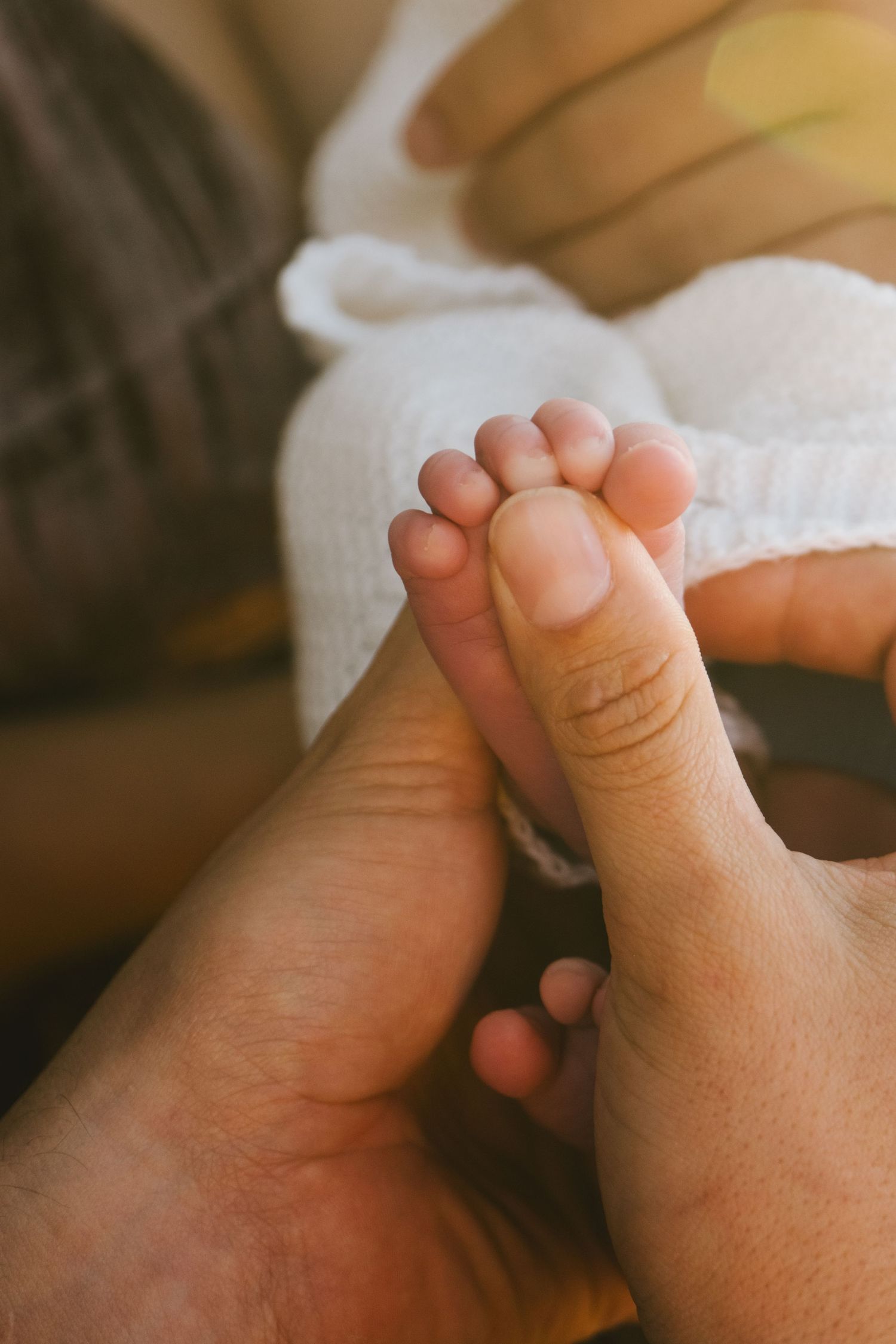 Close-up sequence of tiny baby toes and feet against a soft white background.