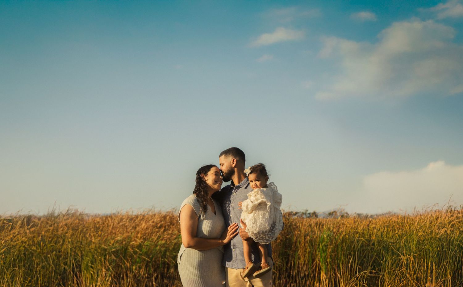 Romantic couple photoshoot in golden cornfield during sunset.