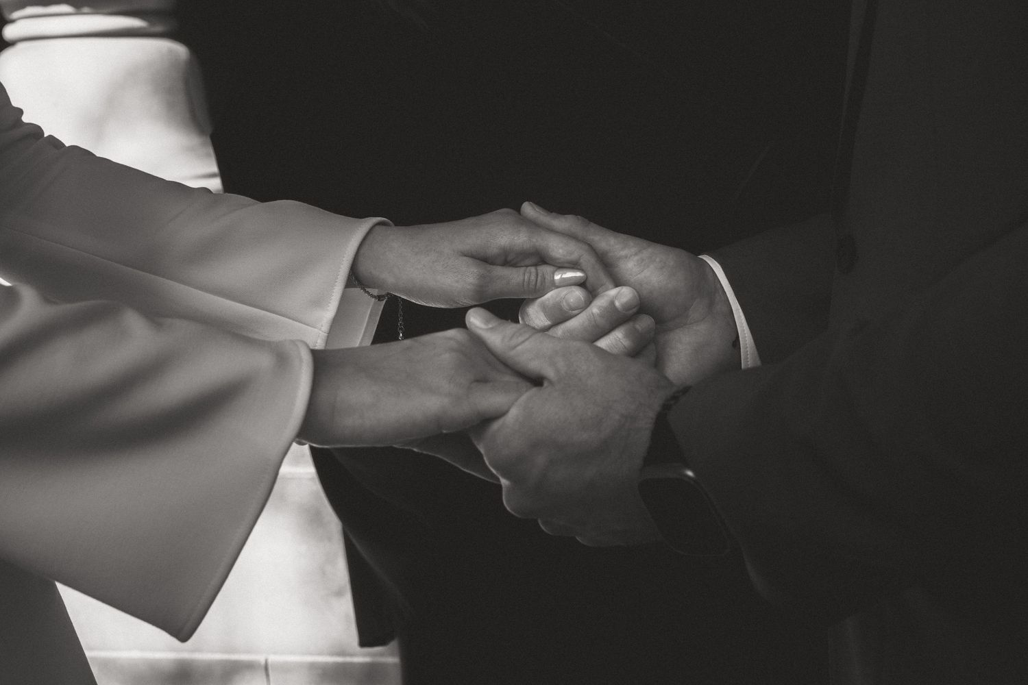Couple exchanging rings in an intimate wedding ceremony.