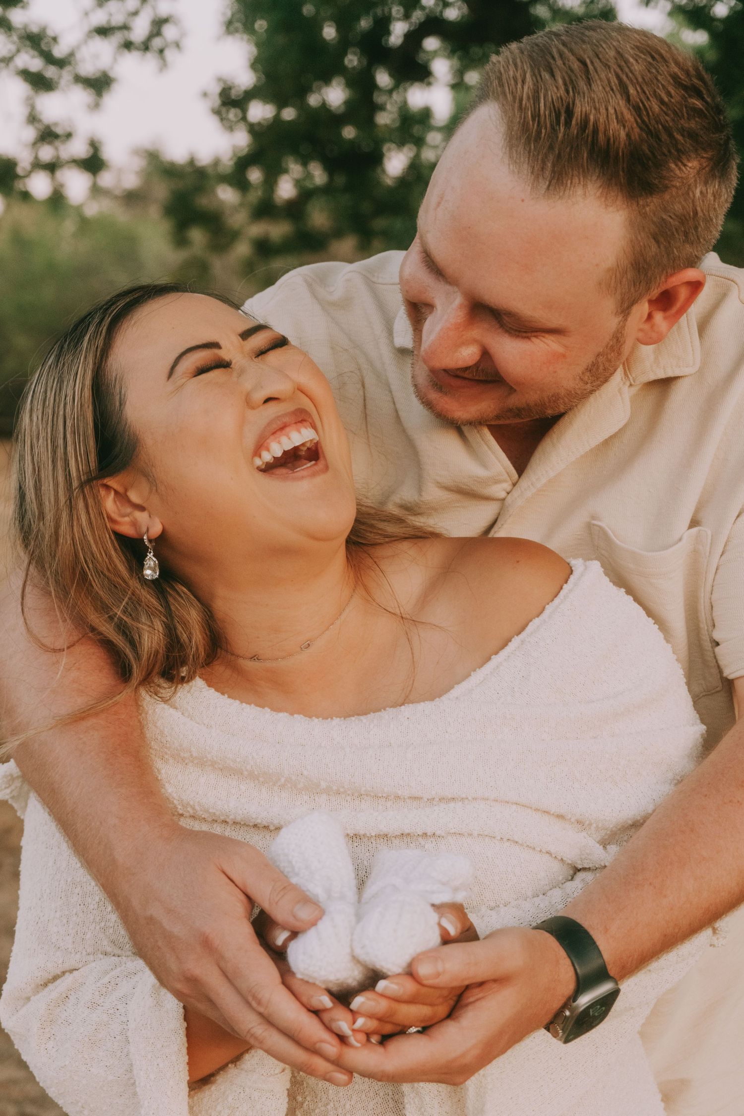 Joyful candid moment captured during sunset outdoor photography session.