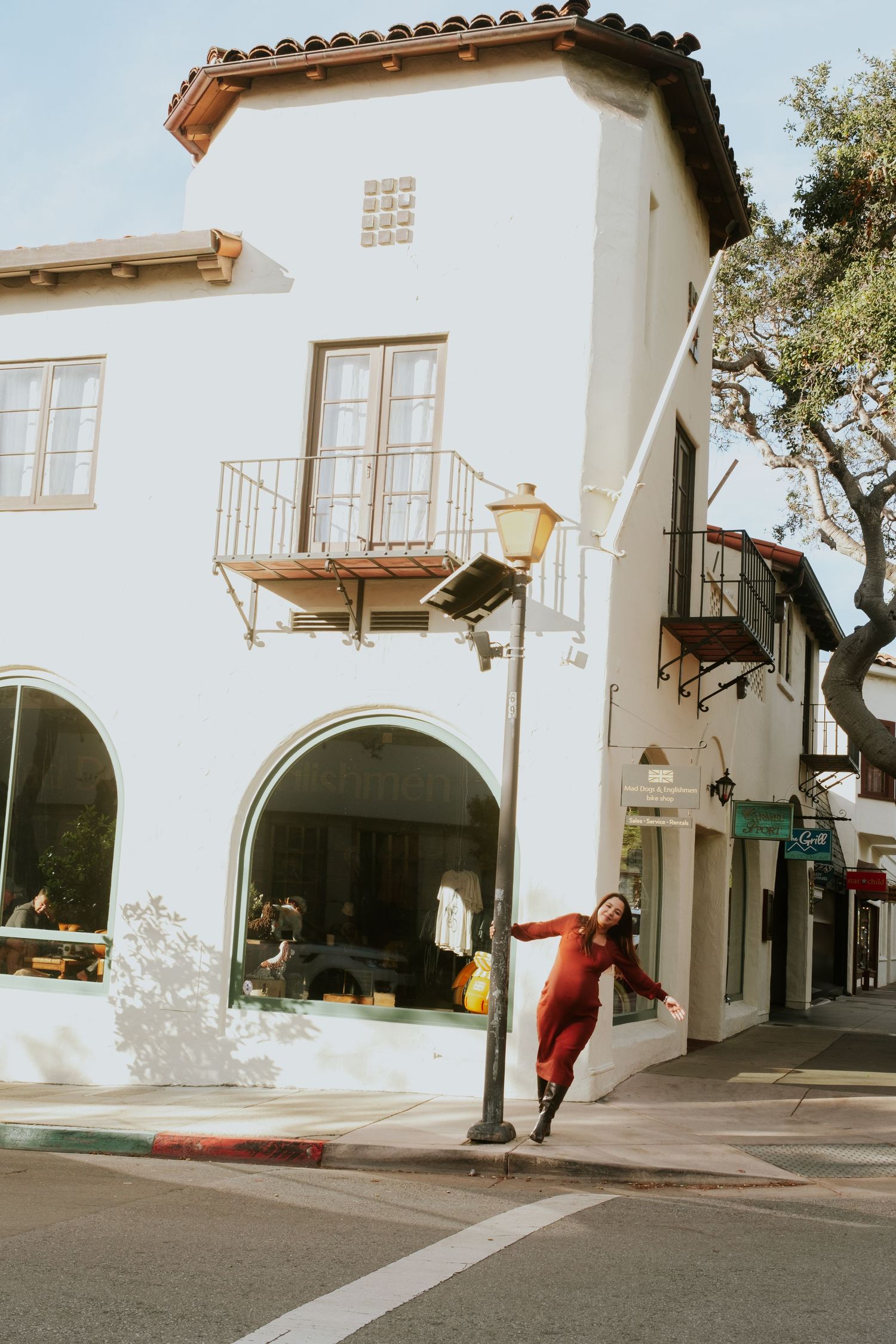 A quiet street lined with Spanish colonial buildings and arched walkways.