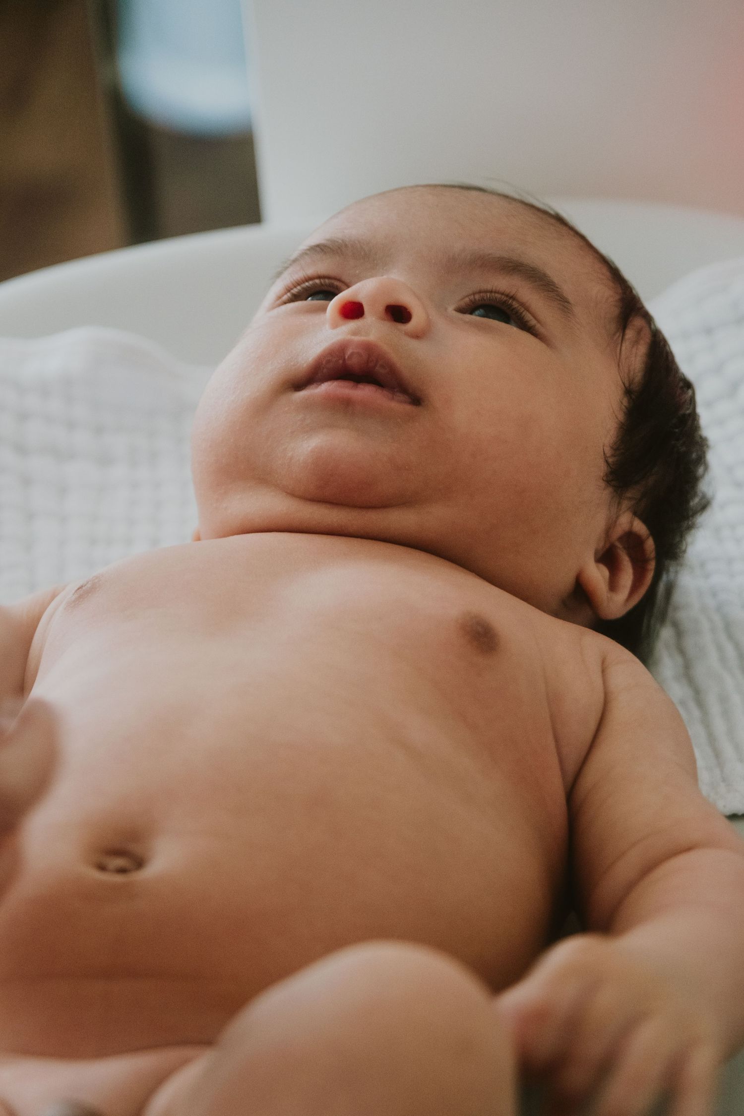 Close-up artistic shots of an infant's features in natural light.
