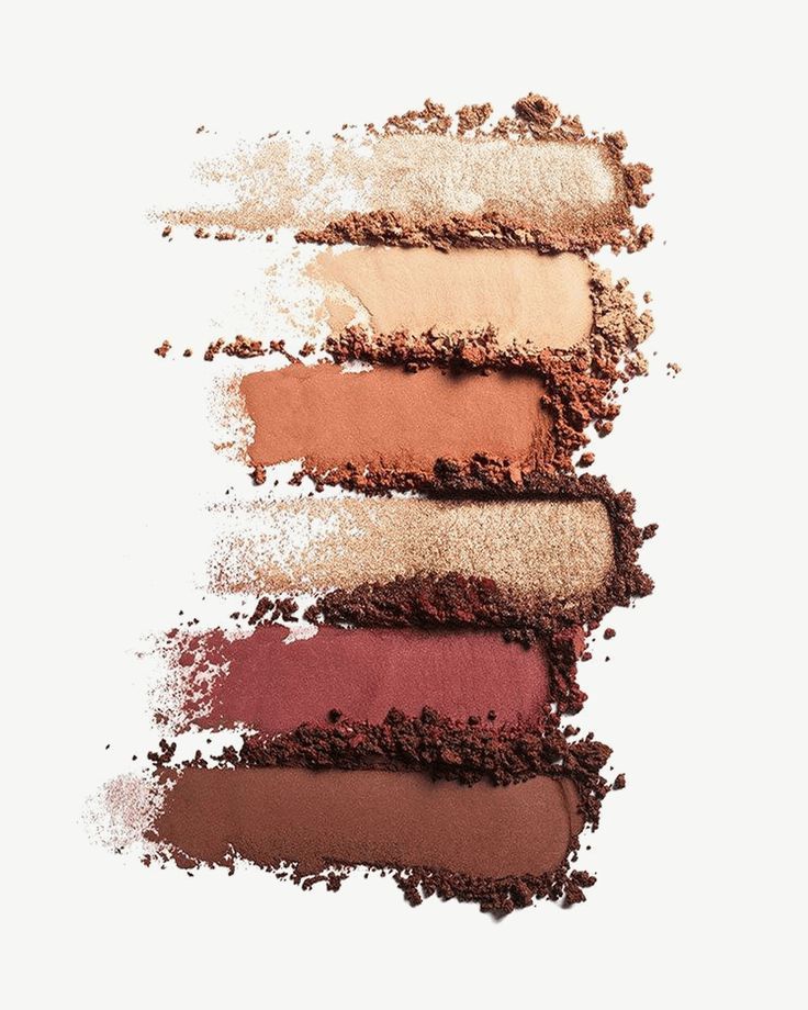 Swatches of neutral and brown eyeshadow powders on white background.