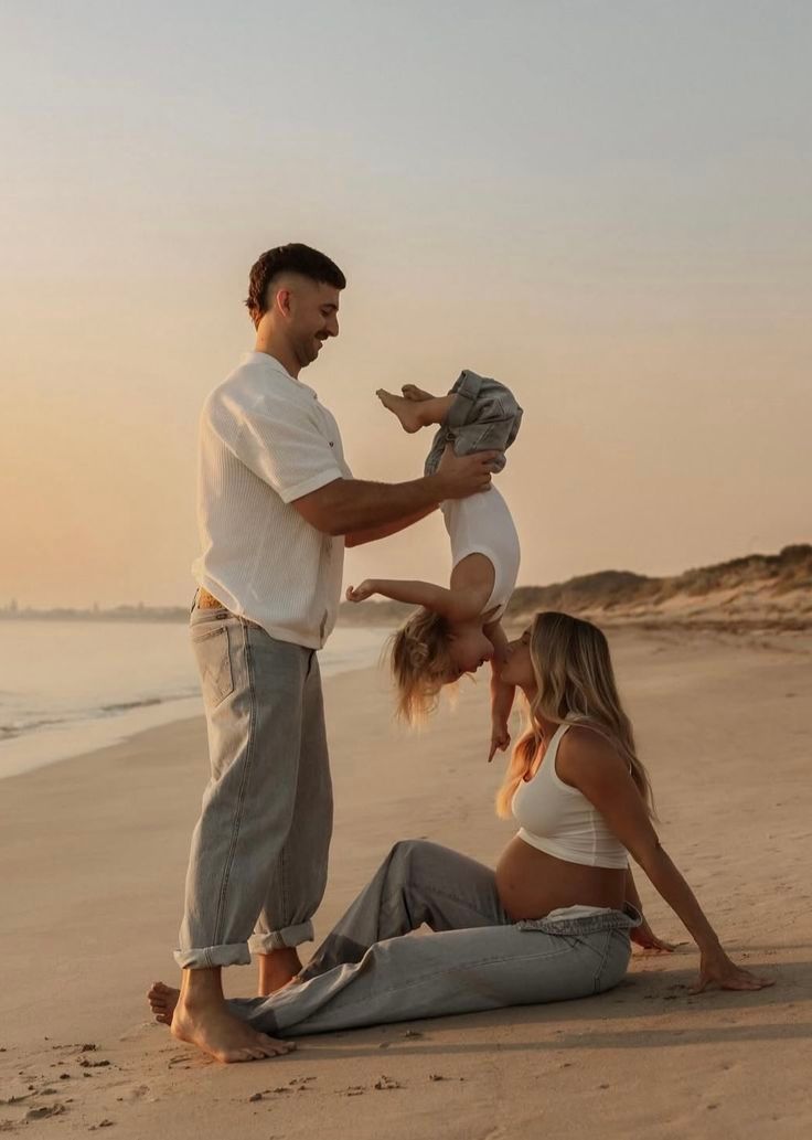 Playful couple having fun on beach at sunset.