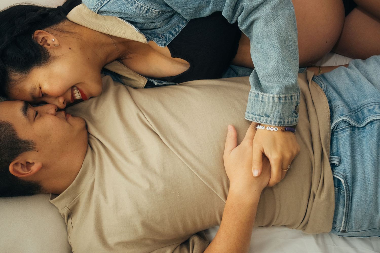 Candid moments captured while resting on beige cushions in natural light.