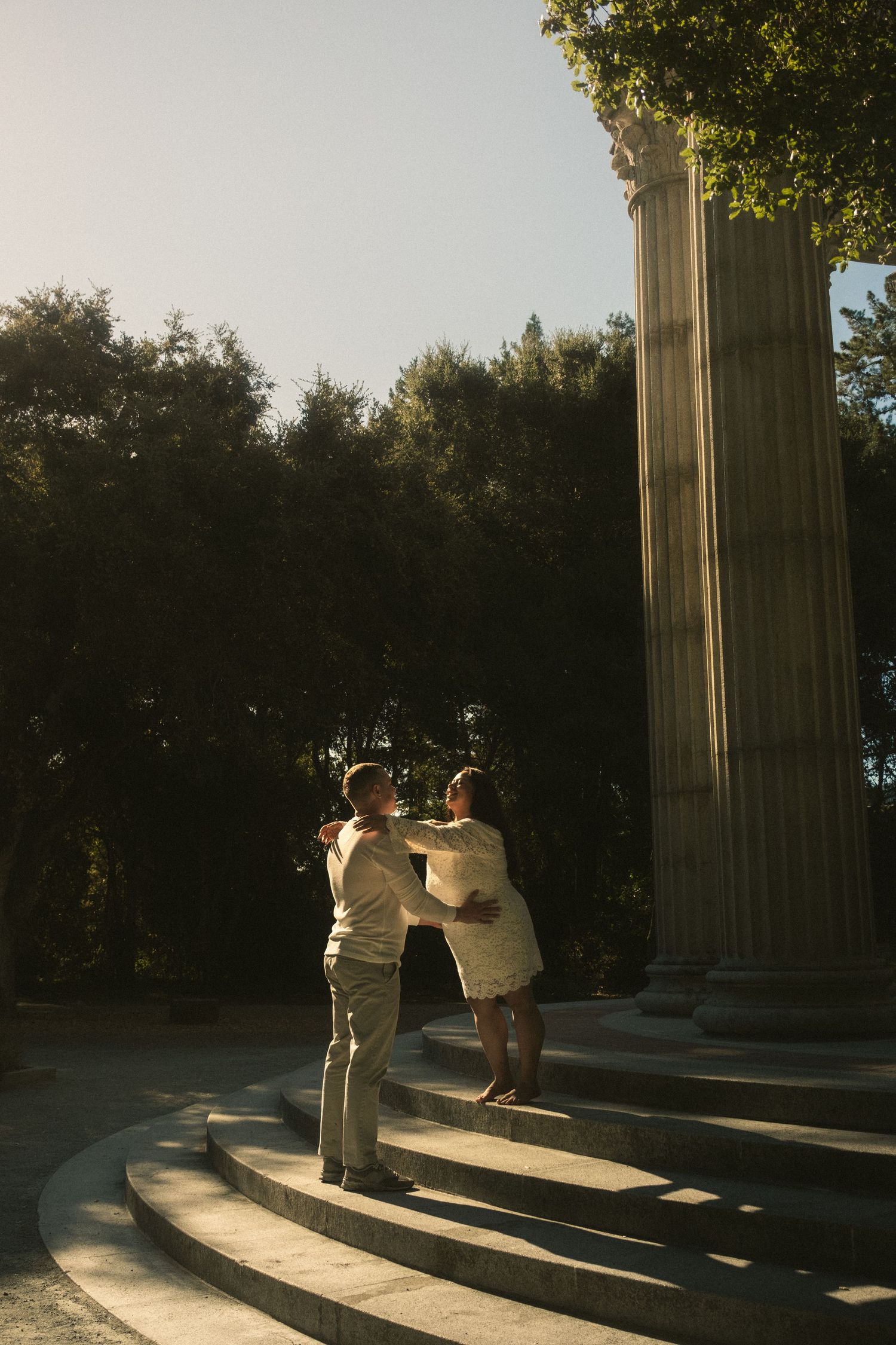 Silhouettes dance on stone steps during golden hour.