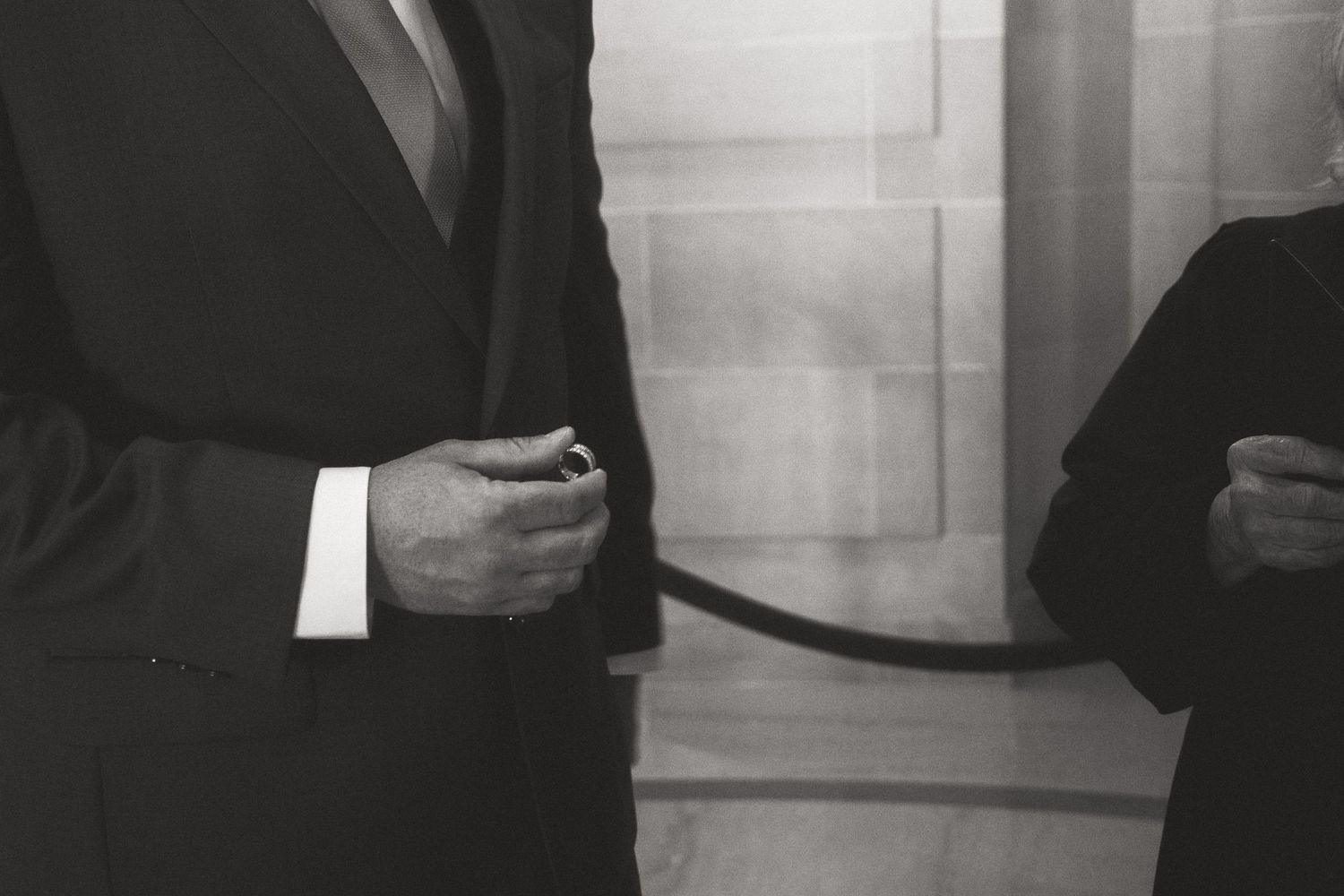 Black and white photo capturing intimate moments during a City Hall wedding ceremony.