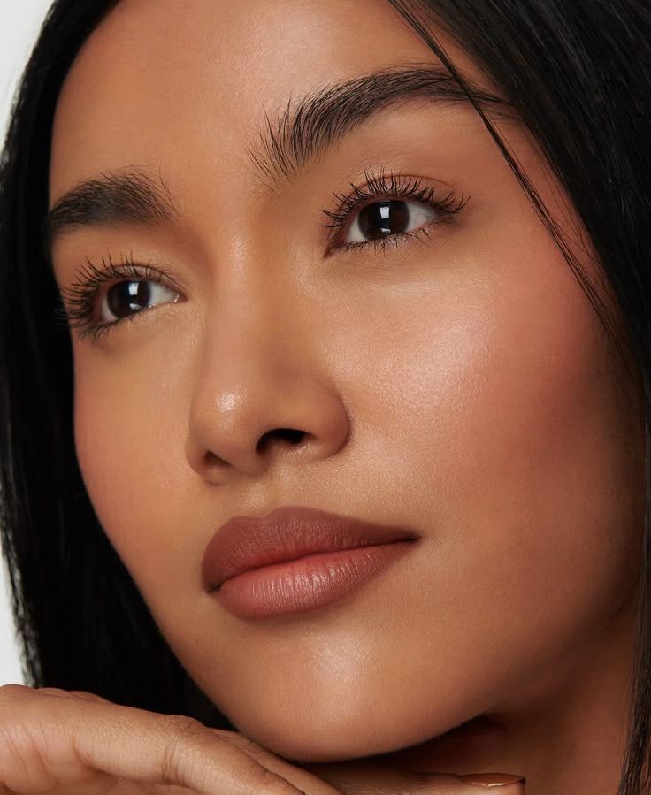 Close-up beauty portrait showcasing natural glowing makeup and flawless skin.