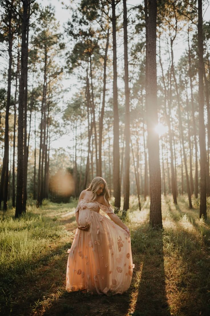 Ethereal sunlit forest scene with flowing dress and dreamy golden light filtering through pine trees.