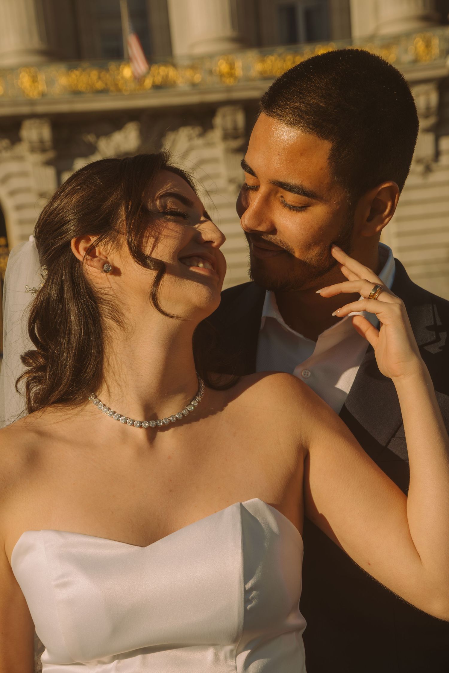 Sunset wedding portraits with warm golden light and elegant architecture.