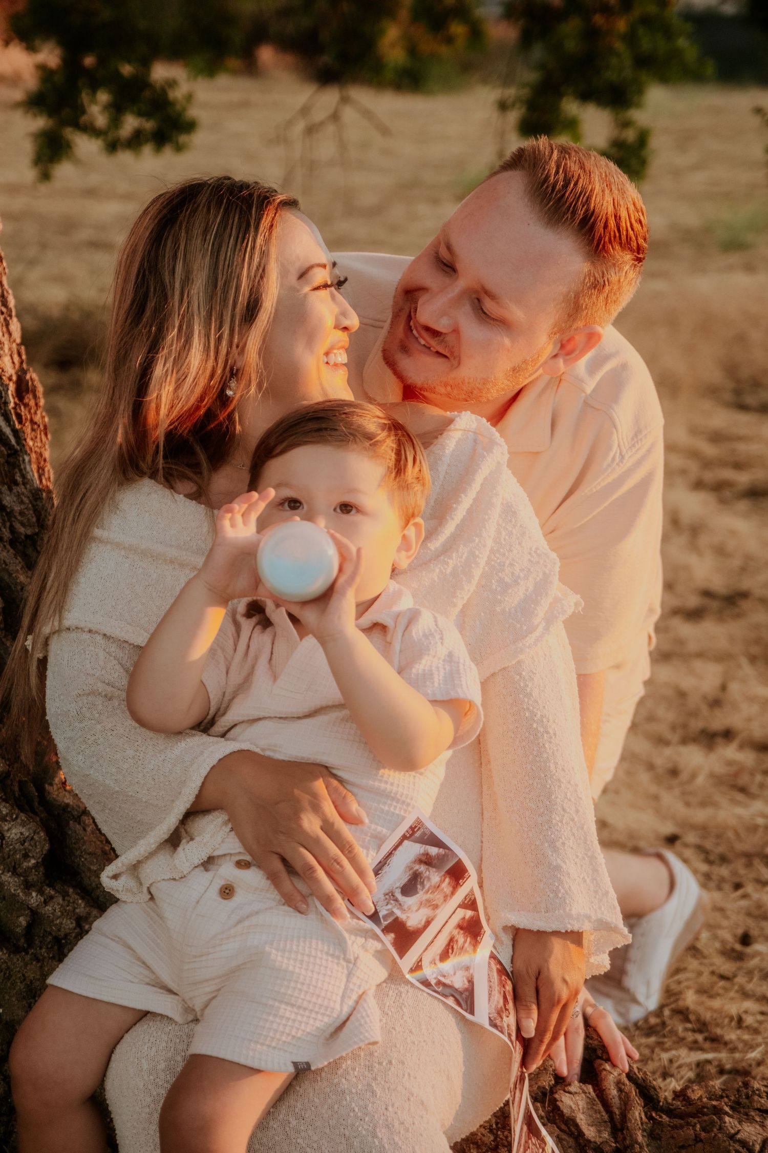 A family shares intimate moments together during a sunset photoshoot.