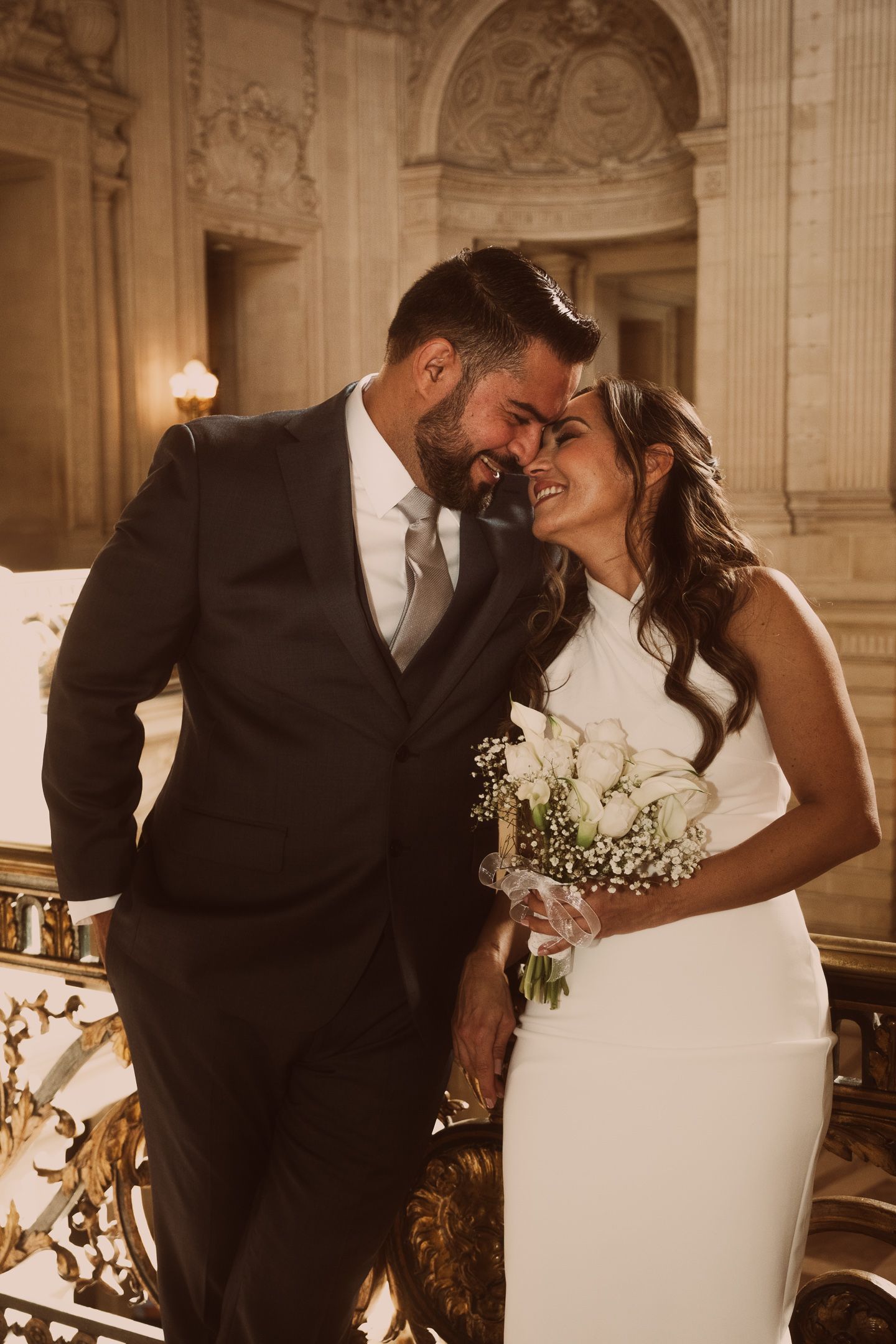 Elegant wedding photos in a grand historic building with ornate architectural details.
