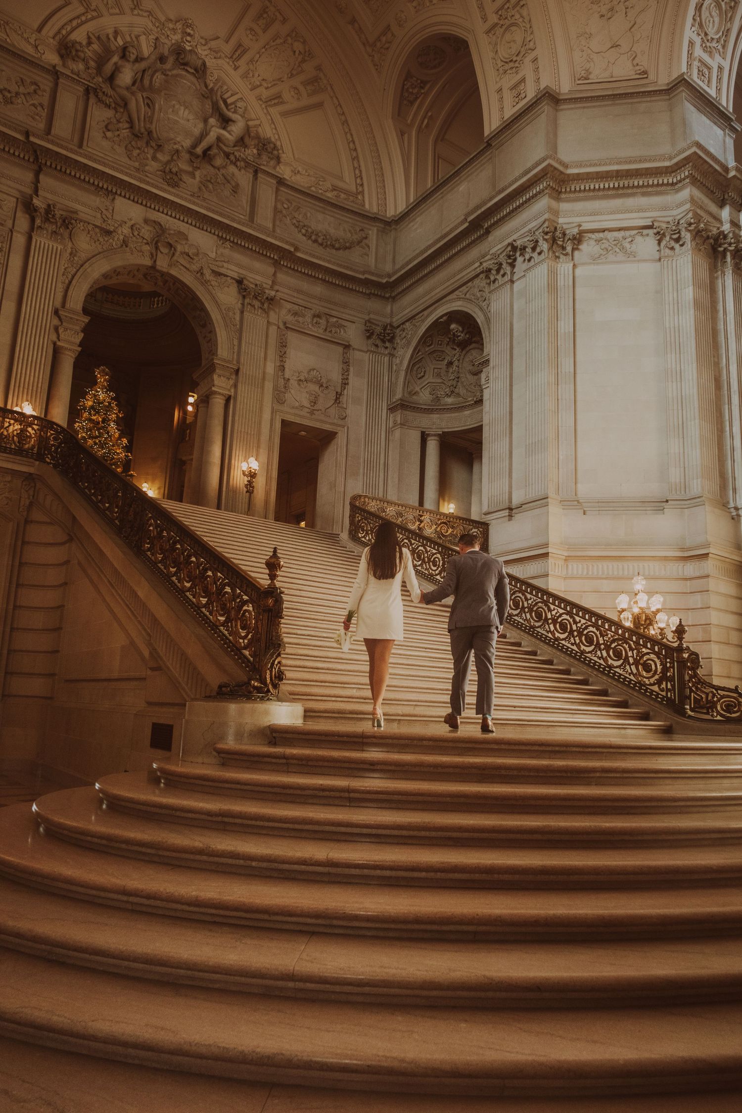 Elegant marble staircase in City Hall with ornate architectural details.
