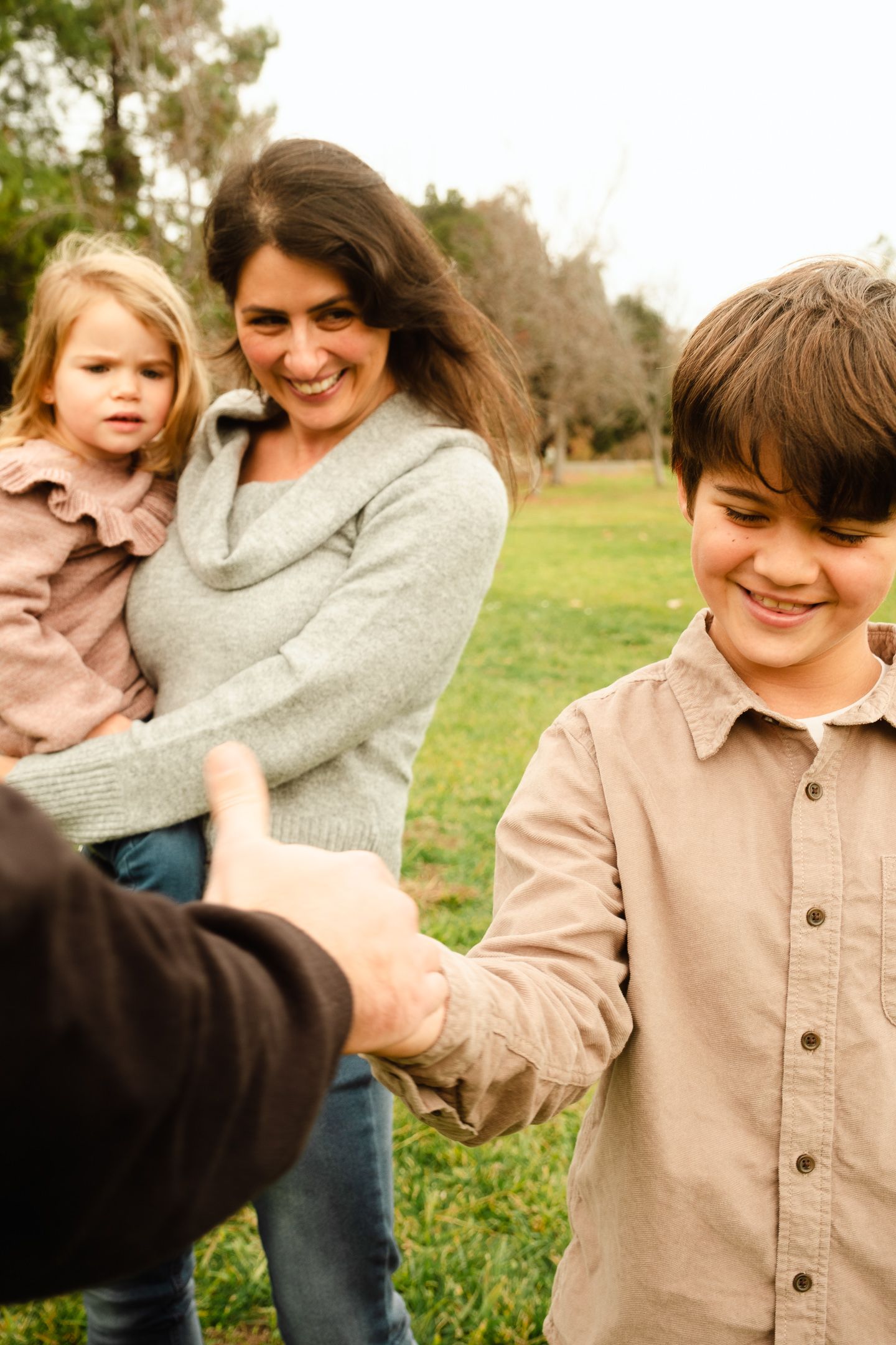 Playful family moments captured in sequence outdoors on a sunny afternoon.