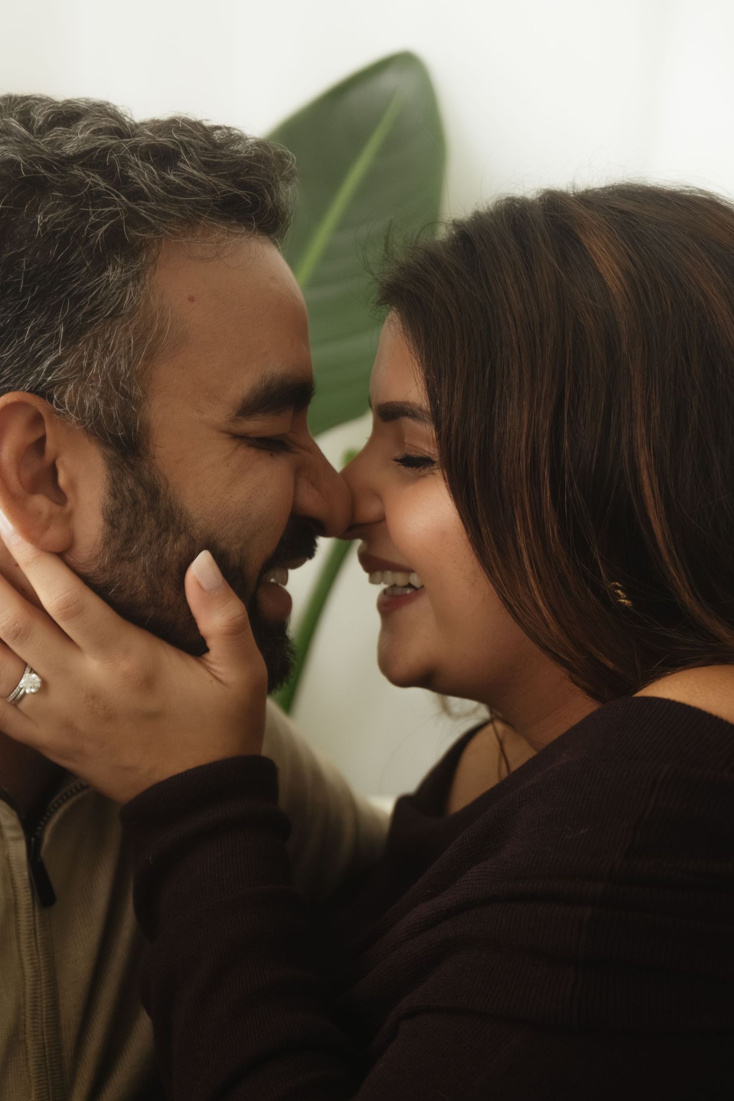 An intimate couples photoshoot with soft lighting and natural decor.