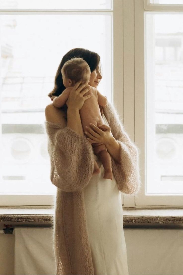 A sequence of tender moments captured between a couple embracing in front of sunlit windows in a bright interior.