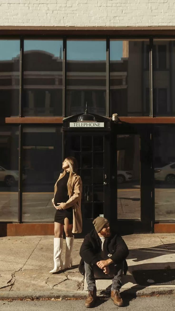 Casual outdoor photoshoot in front of a storefront with modern urban styling.